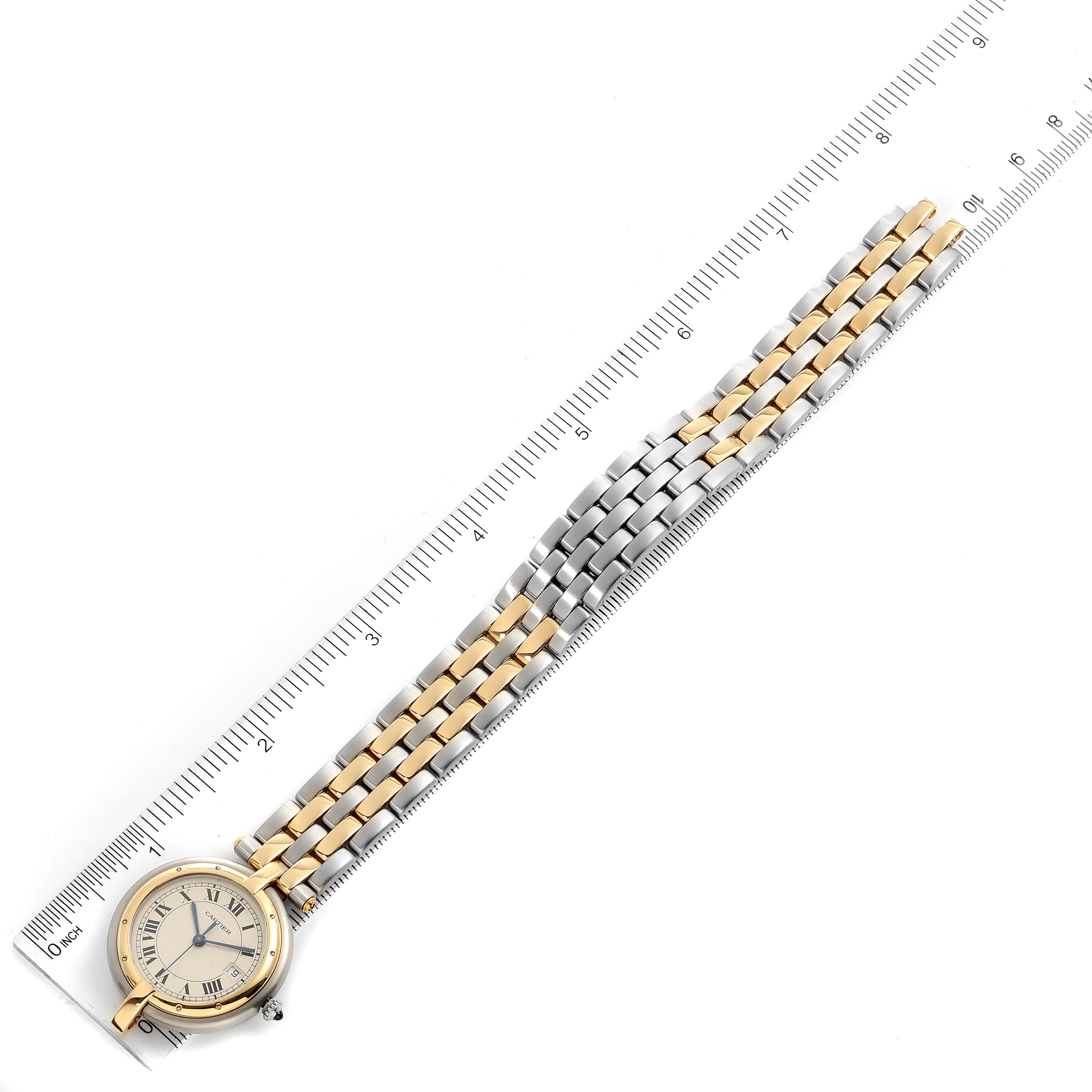 The image shows a Panthere de Cartier watch laid flat with its face and bracelet fully extended next to a ruler.