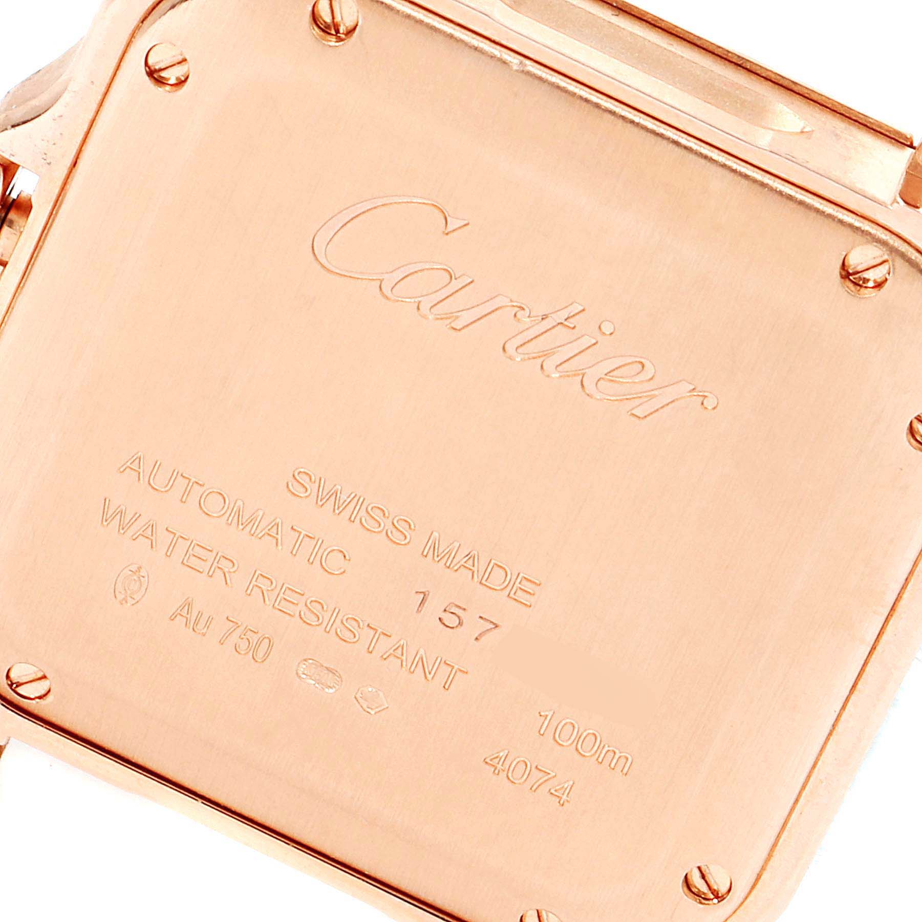This image shows the case back of a Cartier Santos WGSA0012 Men's Rose Gold Silver Dial WGSA0012 Men's Rose Gold Silver Dial watch, highlighting its engravings and screws.
