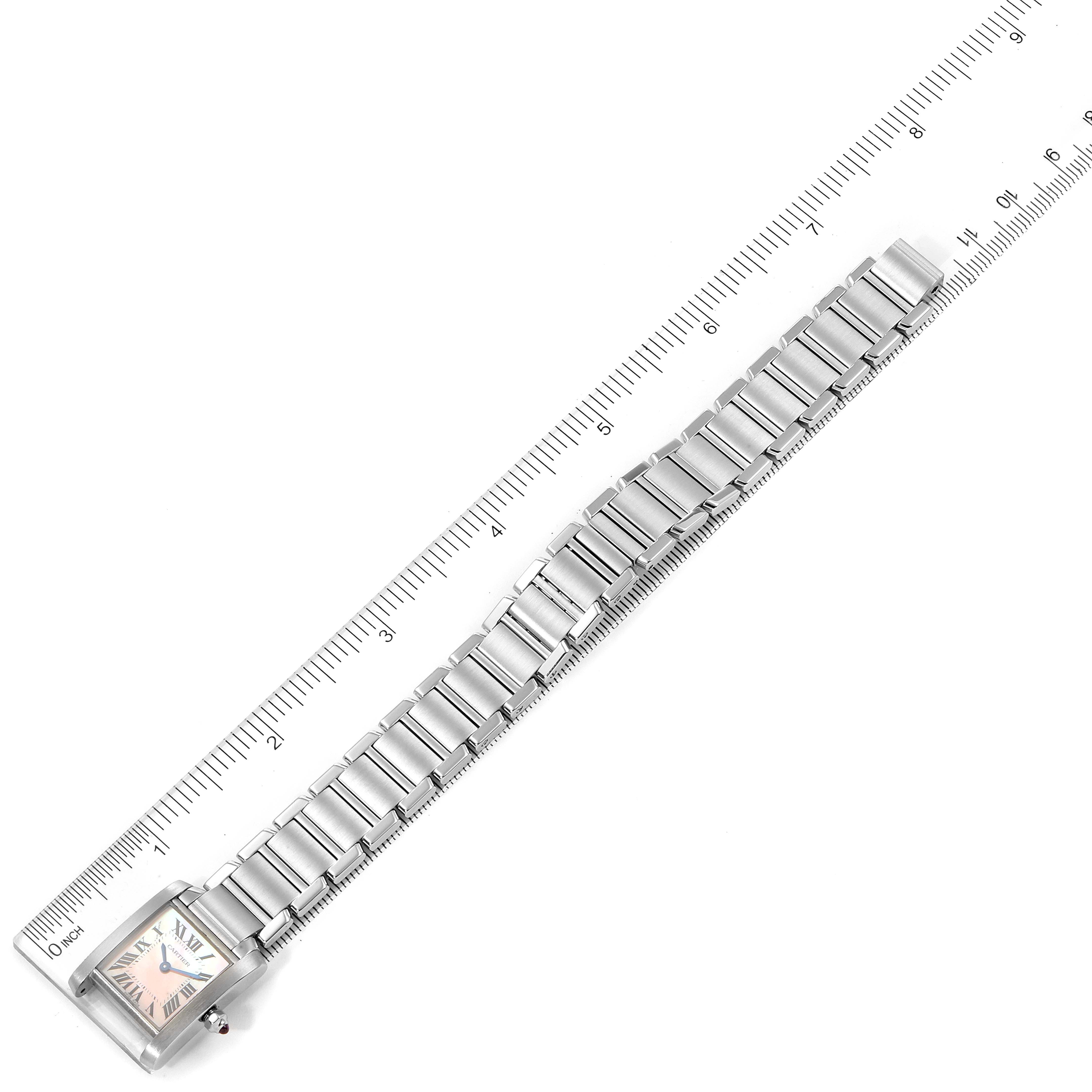 The Tank Francaise by Cartier is shown at a top-down angle, displaying the face and full bracelet, aligned with a ruler for scale.