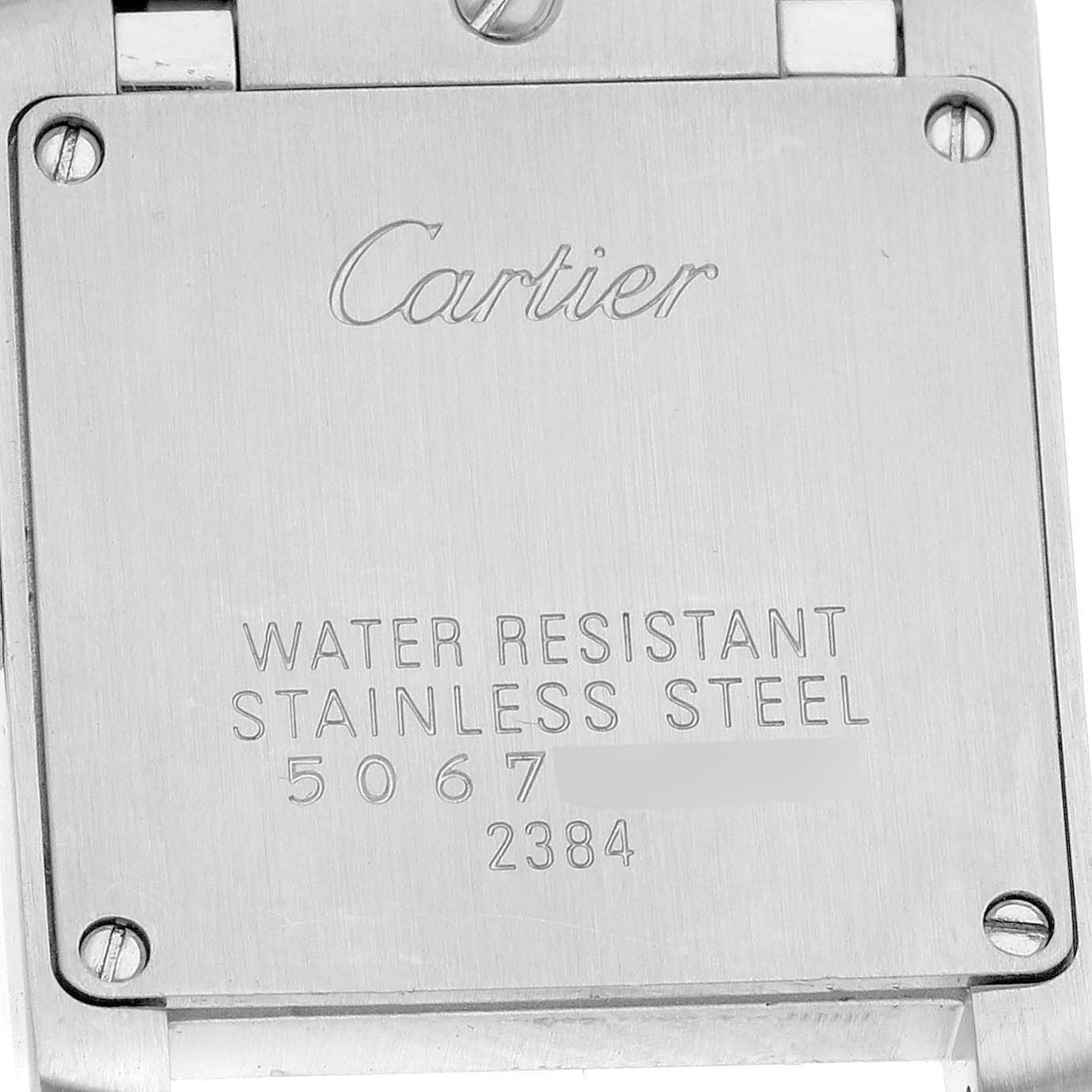 The image shows the back case of a Cartier Tank Francaise W51027Q4 Women's Stainless Steel Mother of Pearl Dial watch, displaying engraving details and screws.