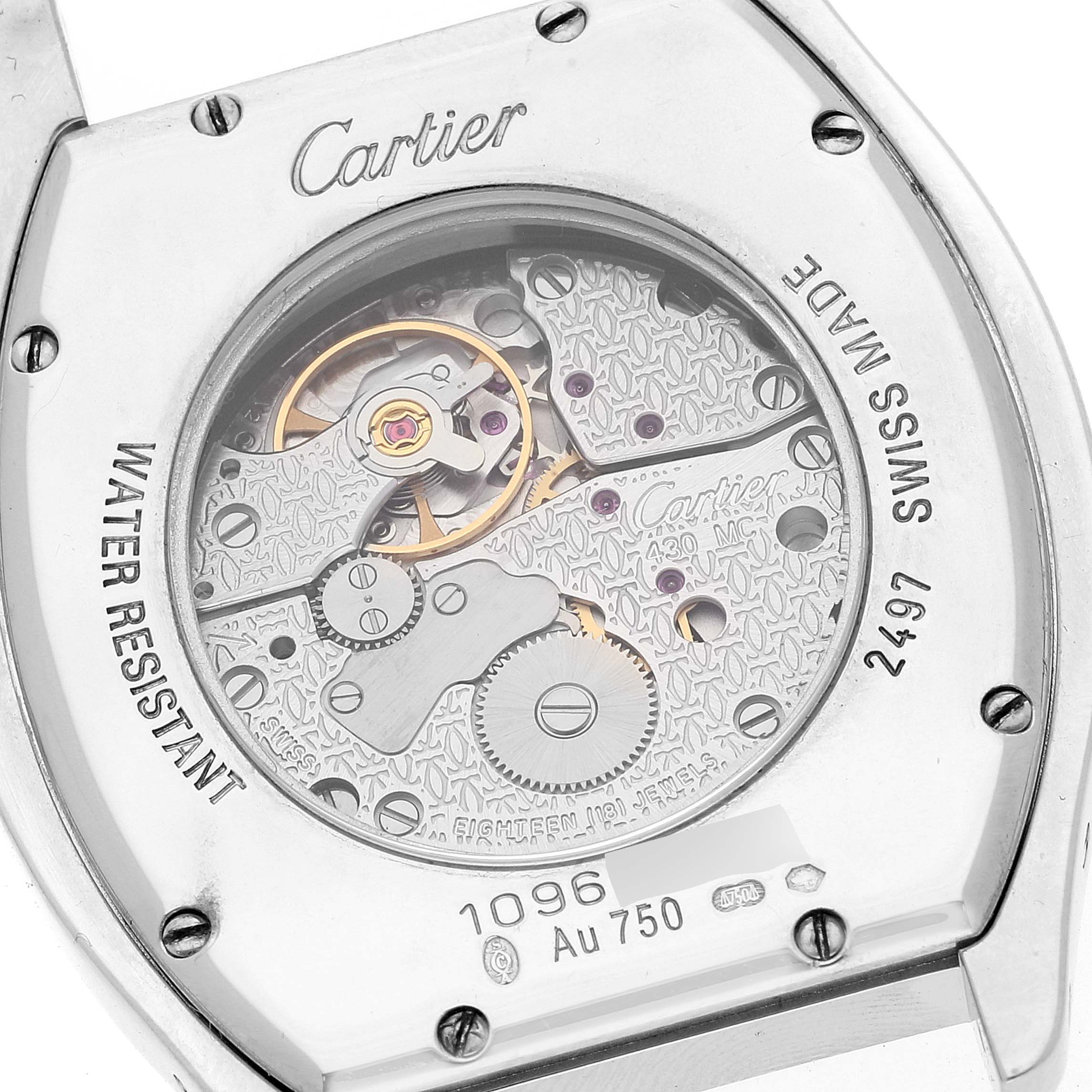 The image shows the back view of the Tortue model by Cartier, revealing its intricate movement and internal mechanism.