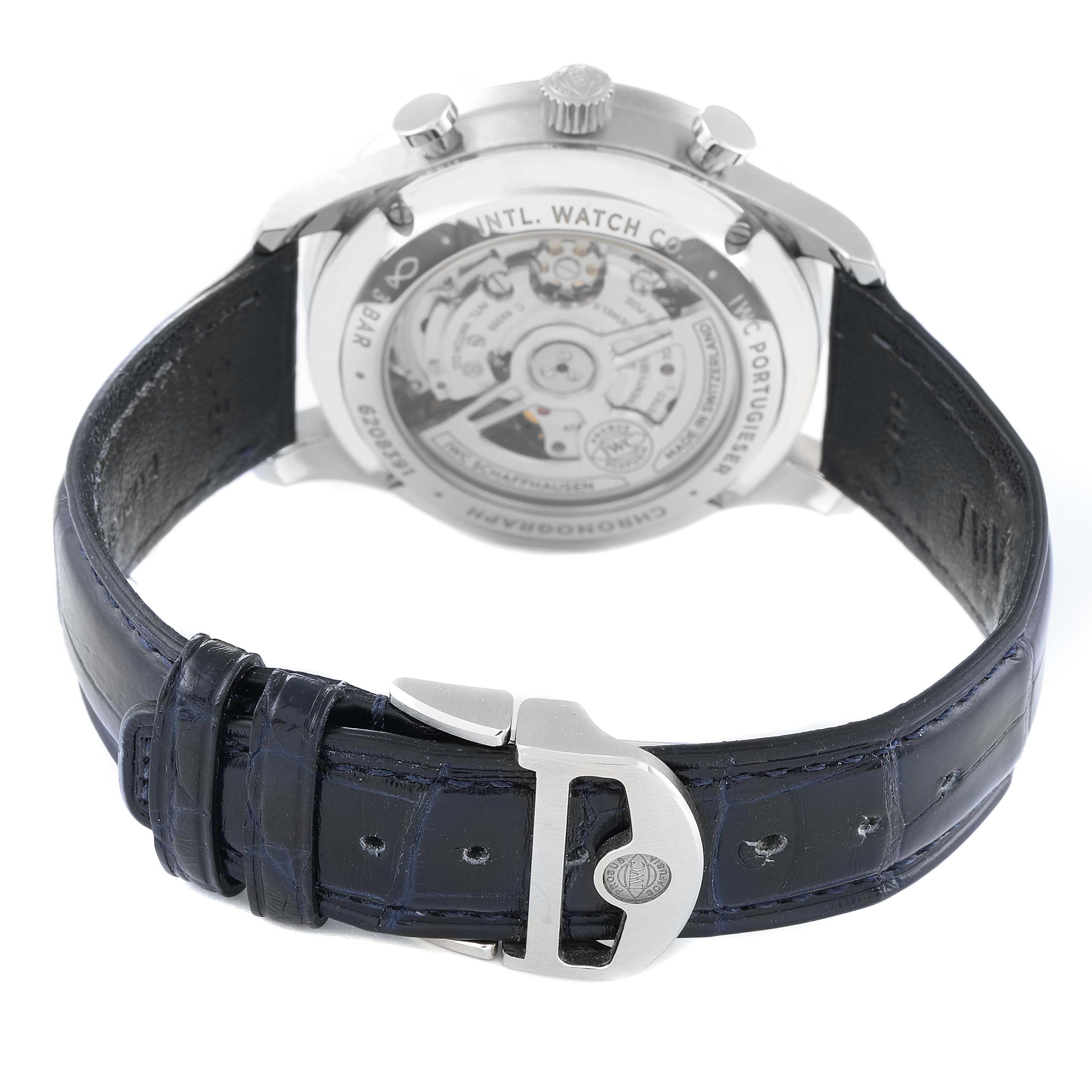 The image shows the rear angle of an IWC Portuguese IW371605 Men's Stainless Steel Silver Dial IW371605 Men's Stainless Steel Silver Dial model watch, highlighting its buckle, leather strap, and transparent case back.