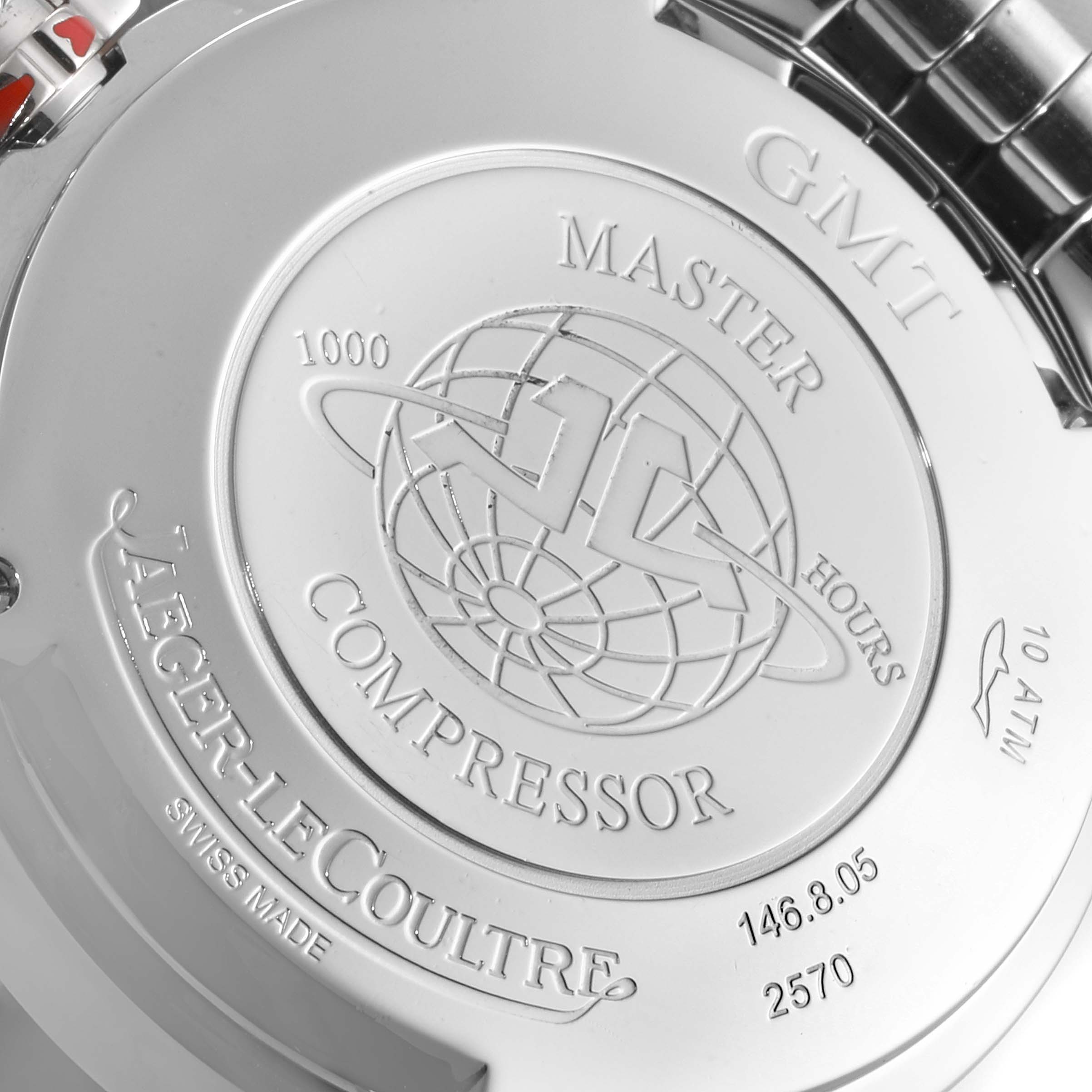 The image shows the back case of a Jaeger-LeCoultre Master Compressor GMT watch, highlighting the engravings and design details.