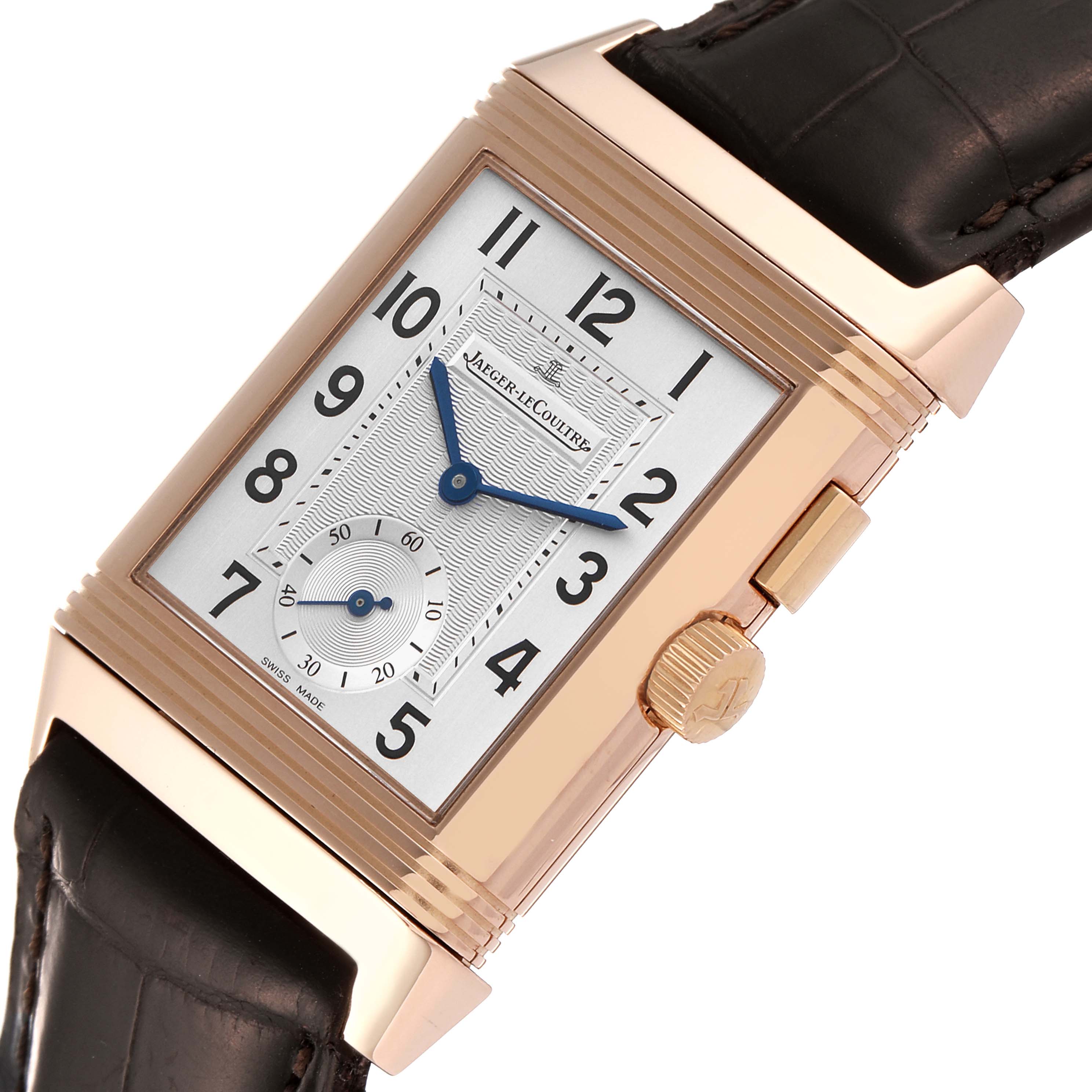 The image shows a close-up angle of a Jaeger LeCoultre Reverso Q2712410 Men's Rose Gold Silver Dial Q2712410 Men's Rose Gold Silver Dial watch, highlighting its face, crown, and leather strap.
