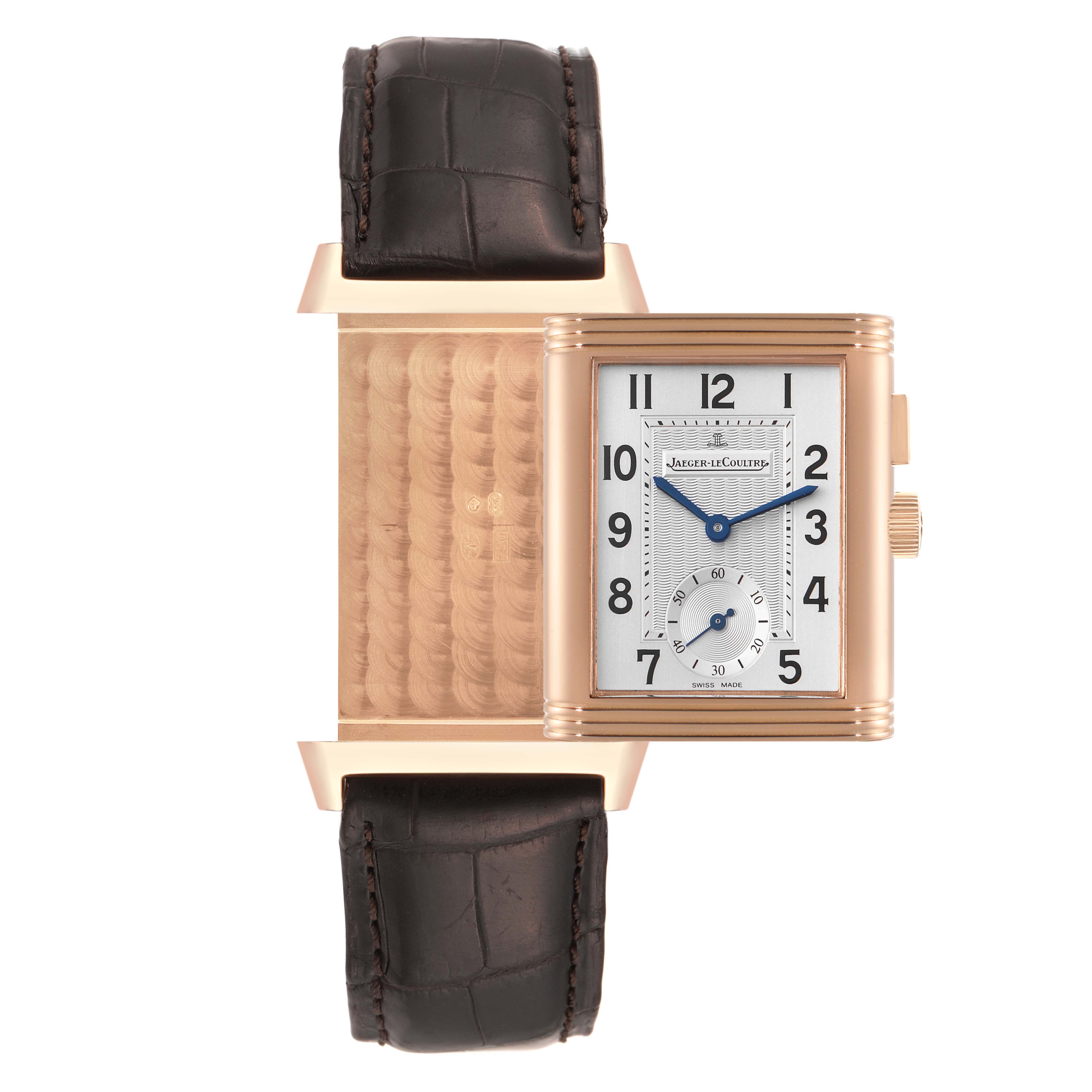 The image shows the Jaeger LeCoultre Reverso Q2712410 Men's Rose Gold Silver Dial Q2712410 Men's Rose Gold Silver Dial watch partially flipped, displaying both the front dial and the intricate reverse side.