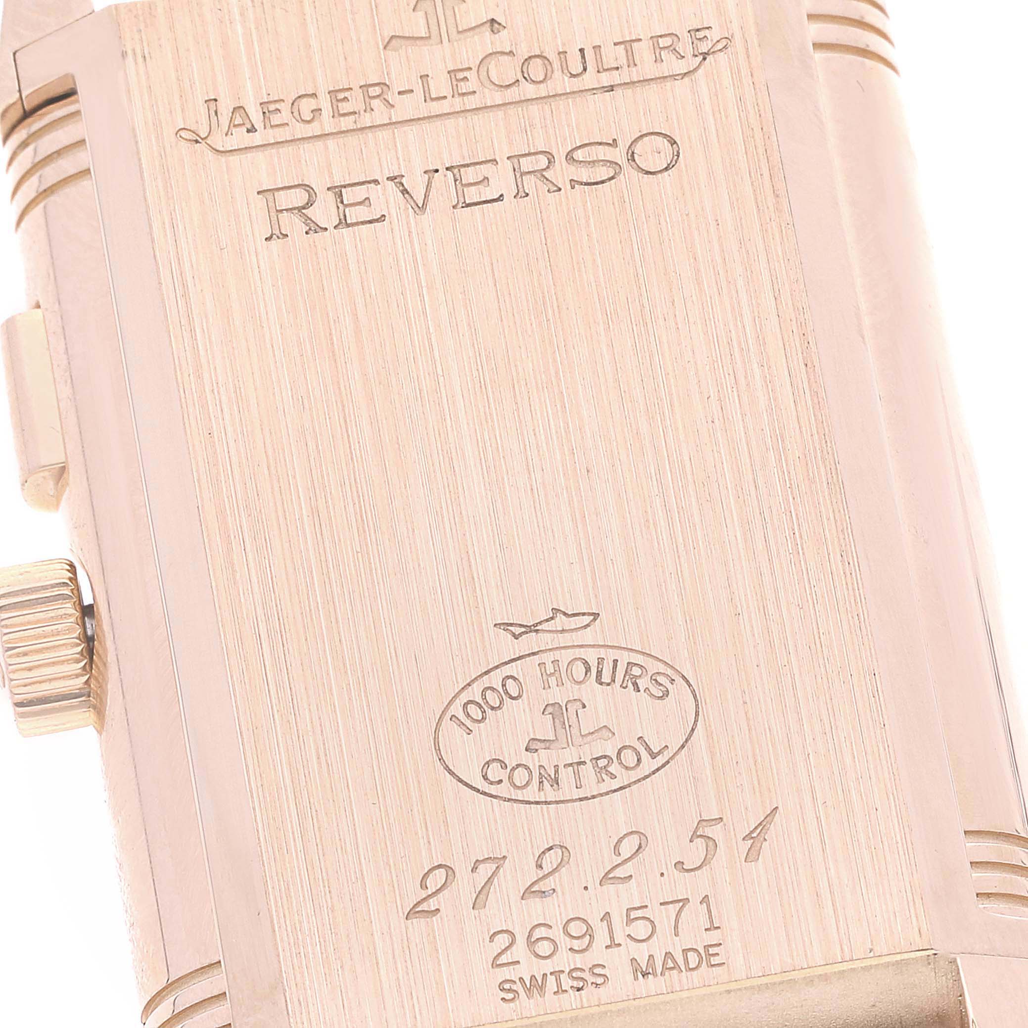 The image shows the back case of a Jaeger-LeCoultre Reverso watch, highlighting its engravings and crown.