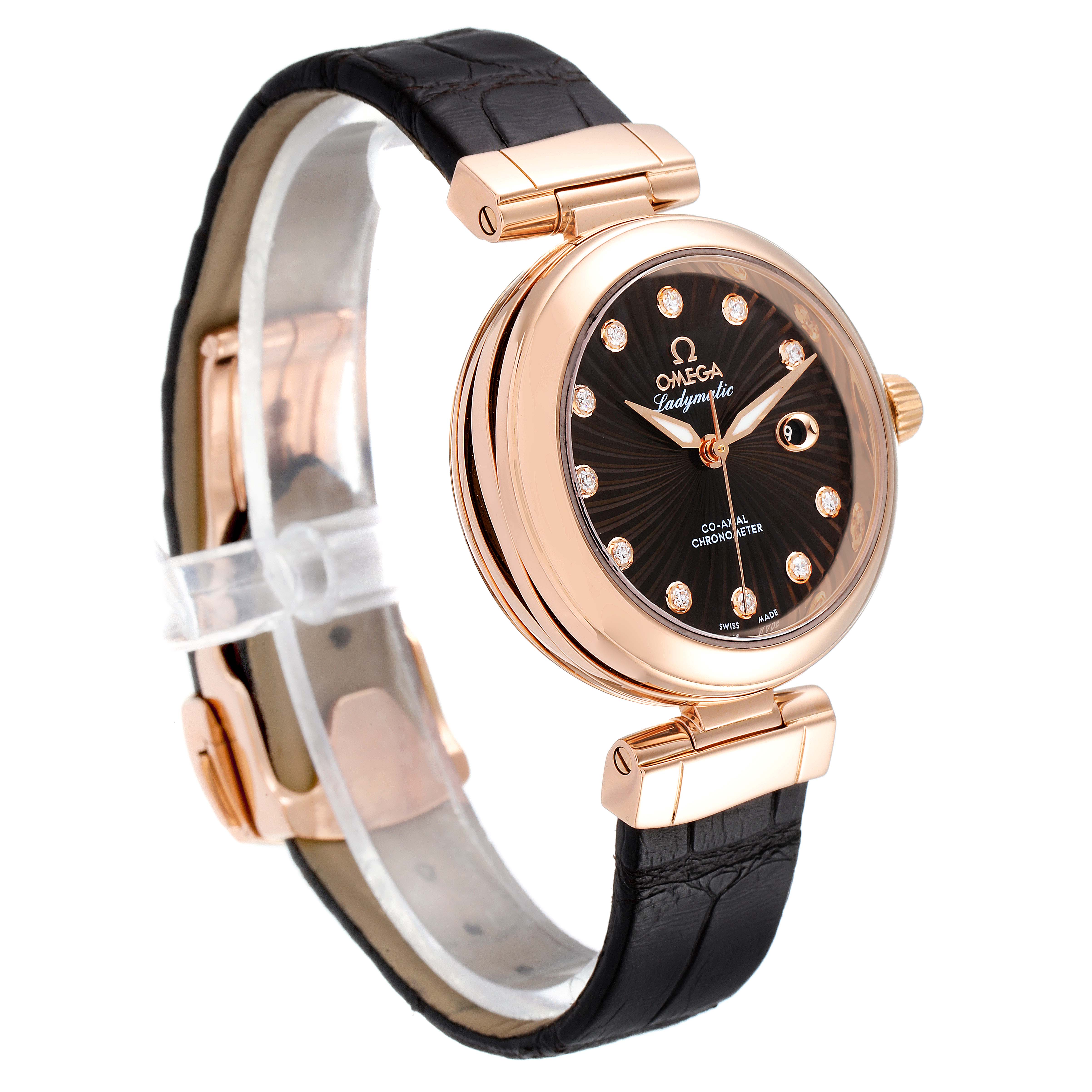 The image shows an angled view of the Omega 425.63.34.20.63.001 Women's Rose Gold Brown Dial 425.63.34.20.63.001 Women's Rose Gold Brown Dial DeVille Ladymatic Rose Gold Diamond Ladies Watch 425.63.34.20.63.001, highlighting its face and strap.