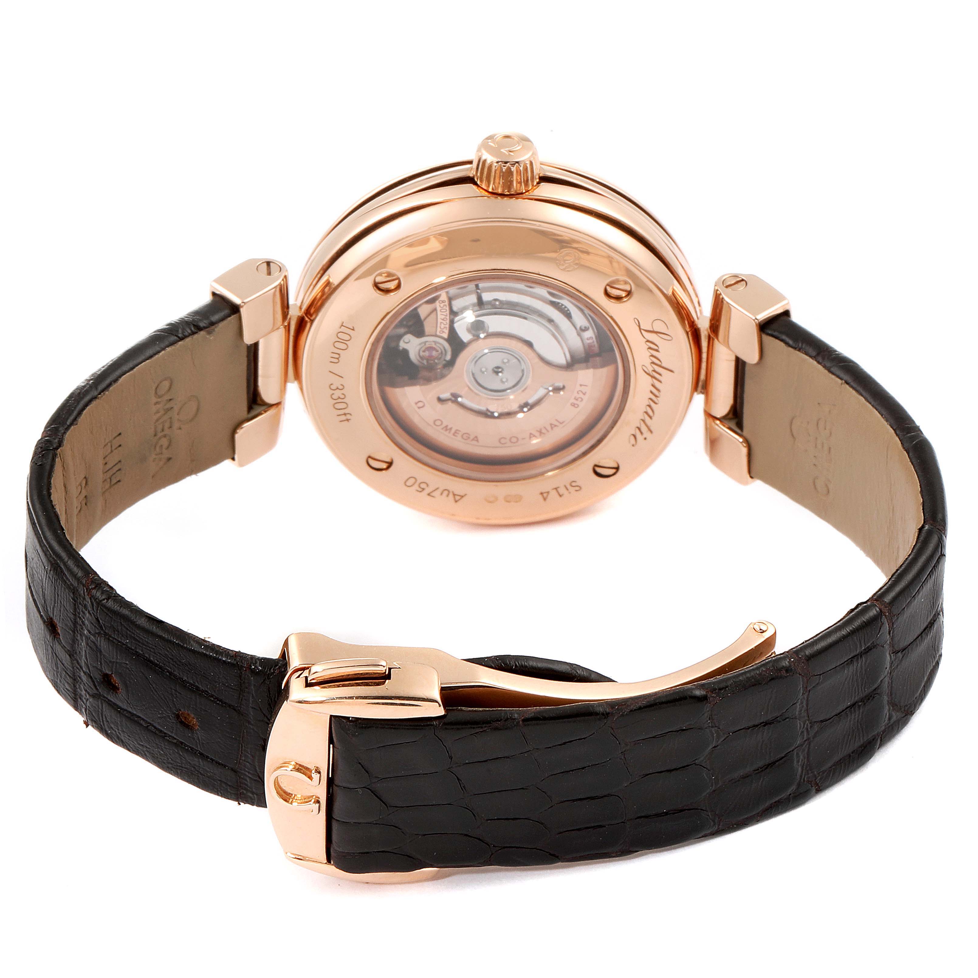 The image shows the back of an Omega 425.63.34.20.63.001 Women's Rose Gold Brown Dial 425.63.34.20.63.001 Women's Rose Gold Brown Dial DeVille Ladymatic Rose Gold Diamond Ladies Watch 425.63.34.20.63.001, highlighting its open case back and strap.