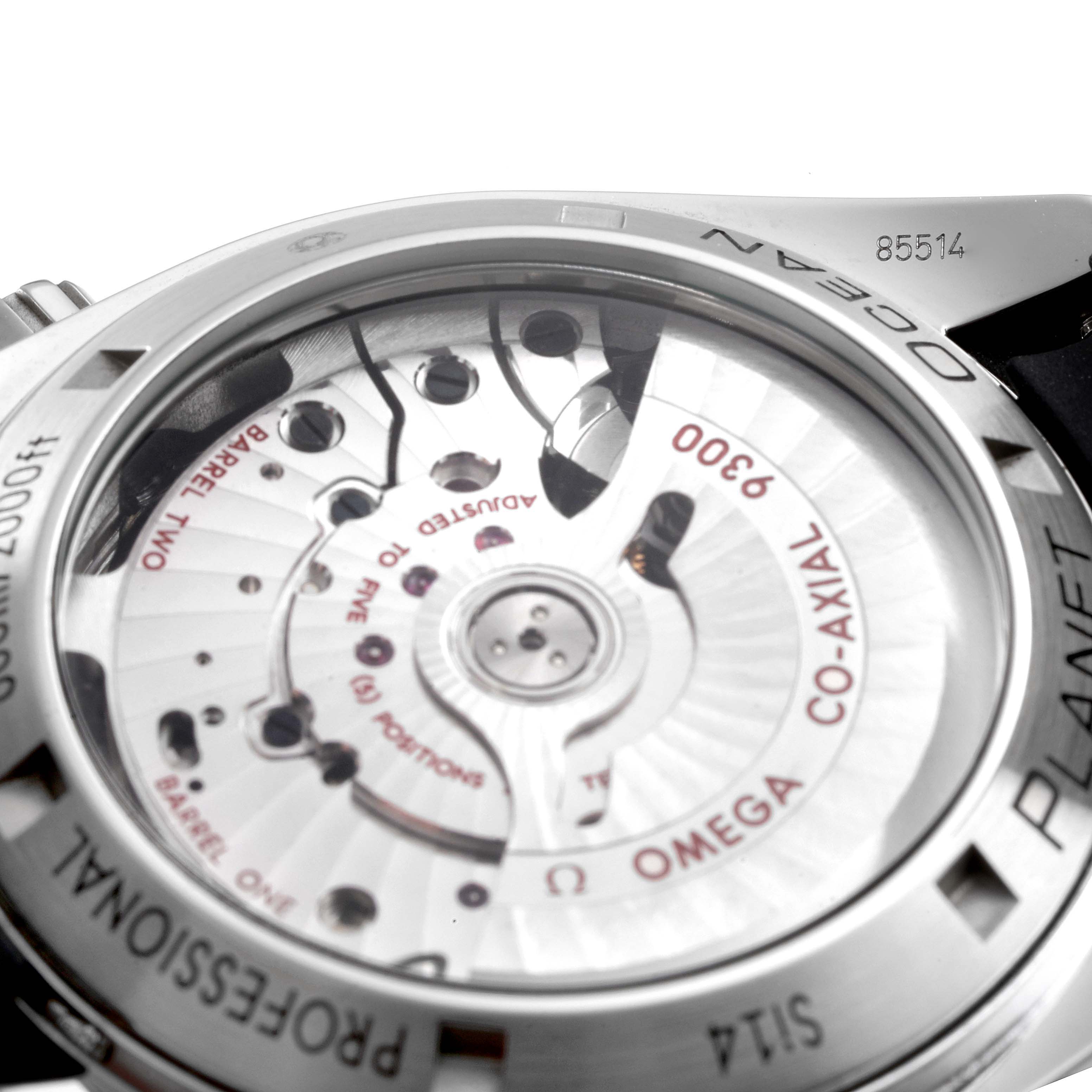 The image shows the back view of the Omega Planet Ocean 232.32.46.51.01.003 Men
s Stainless Steel Black Dial 232.32.46.51.01.003 Men
s Stainless Steel Black Dial watch, highlighting the Co-Axial movement and stainless steel case.