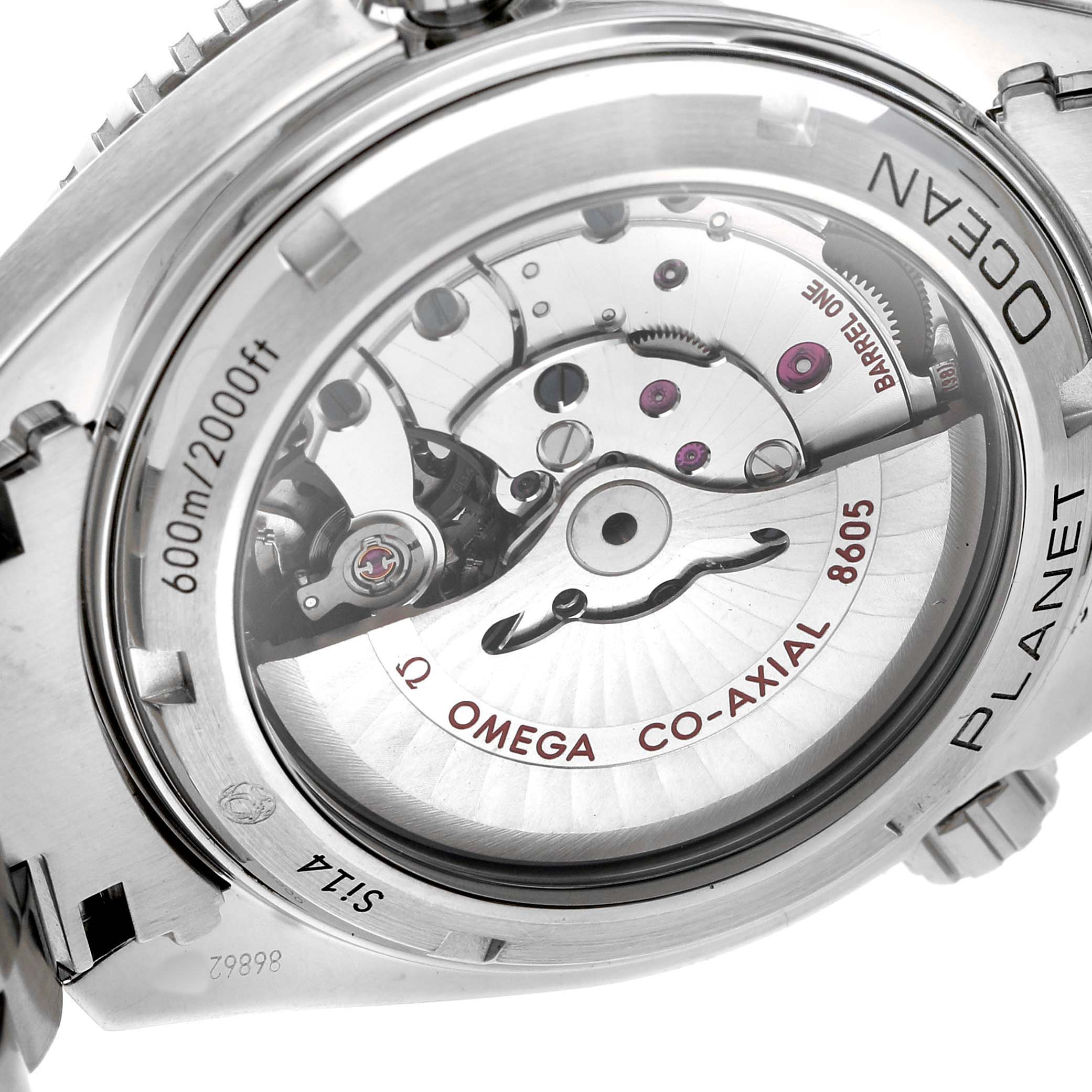 The image shows the back view of an Omega Planet Ocean 232.30.44.22.01.002 Men's Stainless Steel Black Dial watch, highlighting its Co-Axial movement and case details.