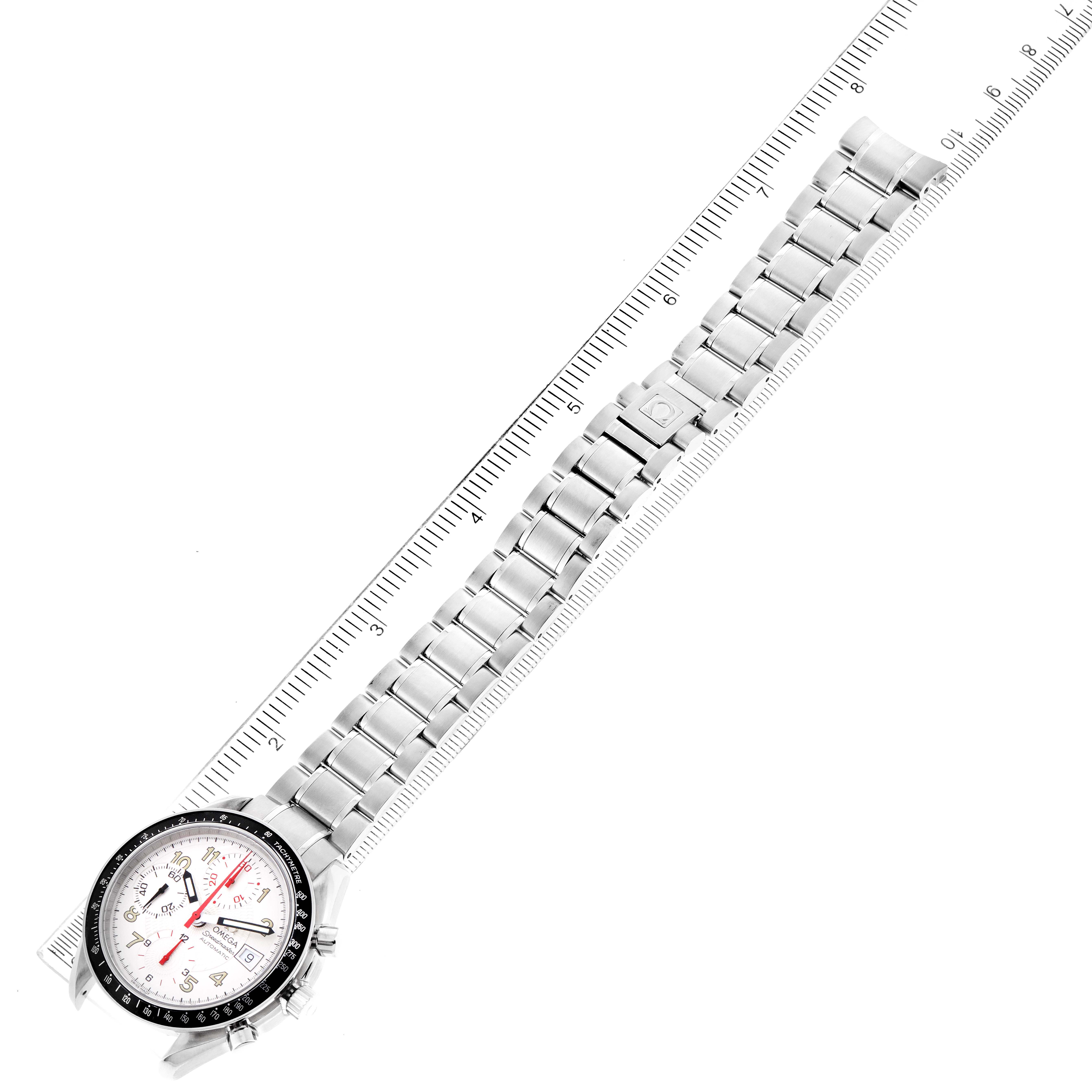 The image shows an Omega Speedmaster 3513.33.00 Men
s Stainless Steel White Dial 3513.33.00 Men
s Stainless Steel White Dial watch laid flat next to a ruler, displaying the watch face and entire metal bracelet.