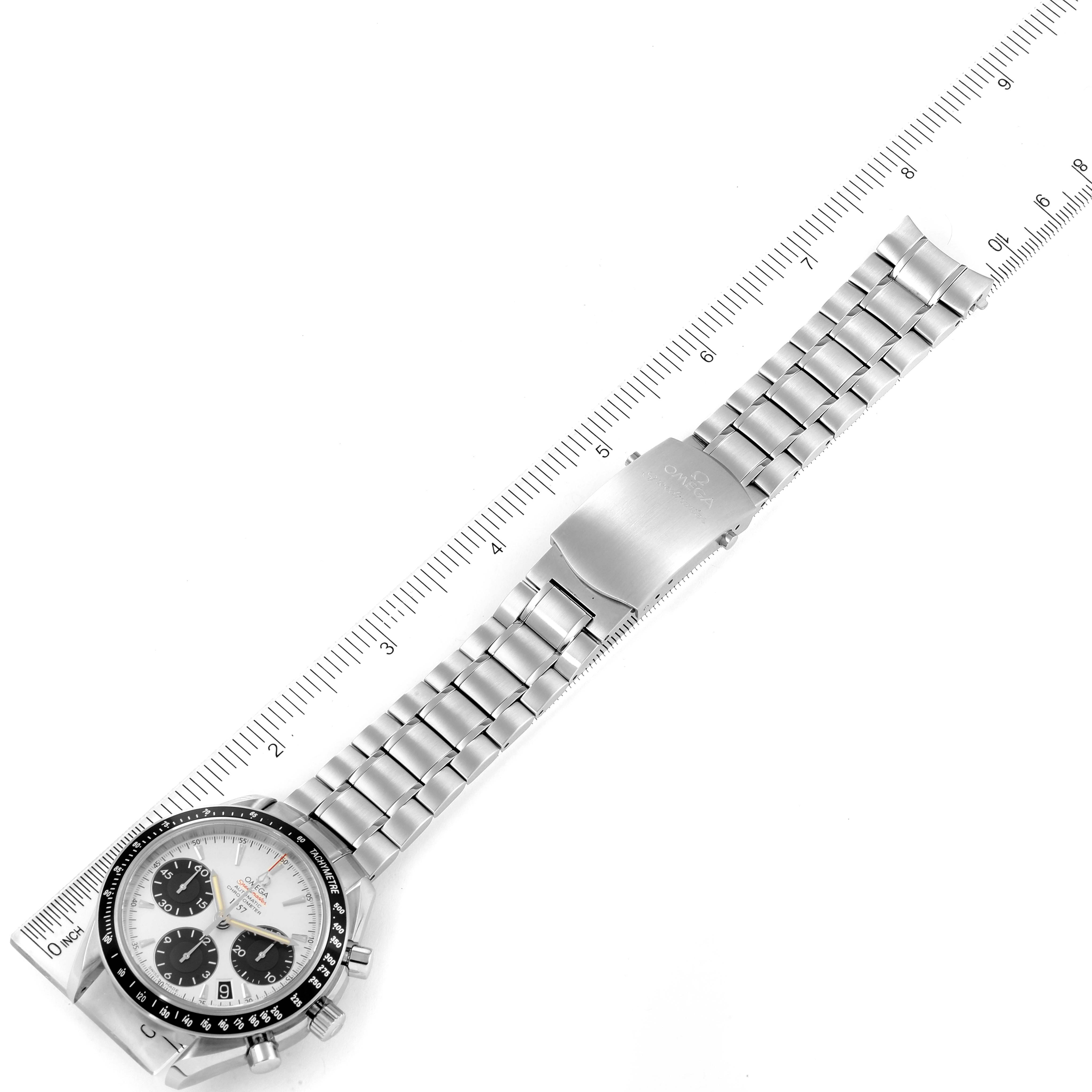The image shows an Omega Speedmaster 323.30.40.40.02.001 Men's Stainless Steel White Dial 323.30.40.40.02.001 Men's Stainless Steel White Dial watch laid flat with its dial and full bracelet visible, beside a ruler for scale.