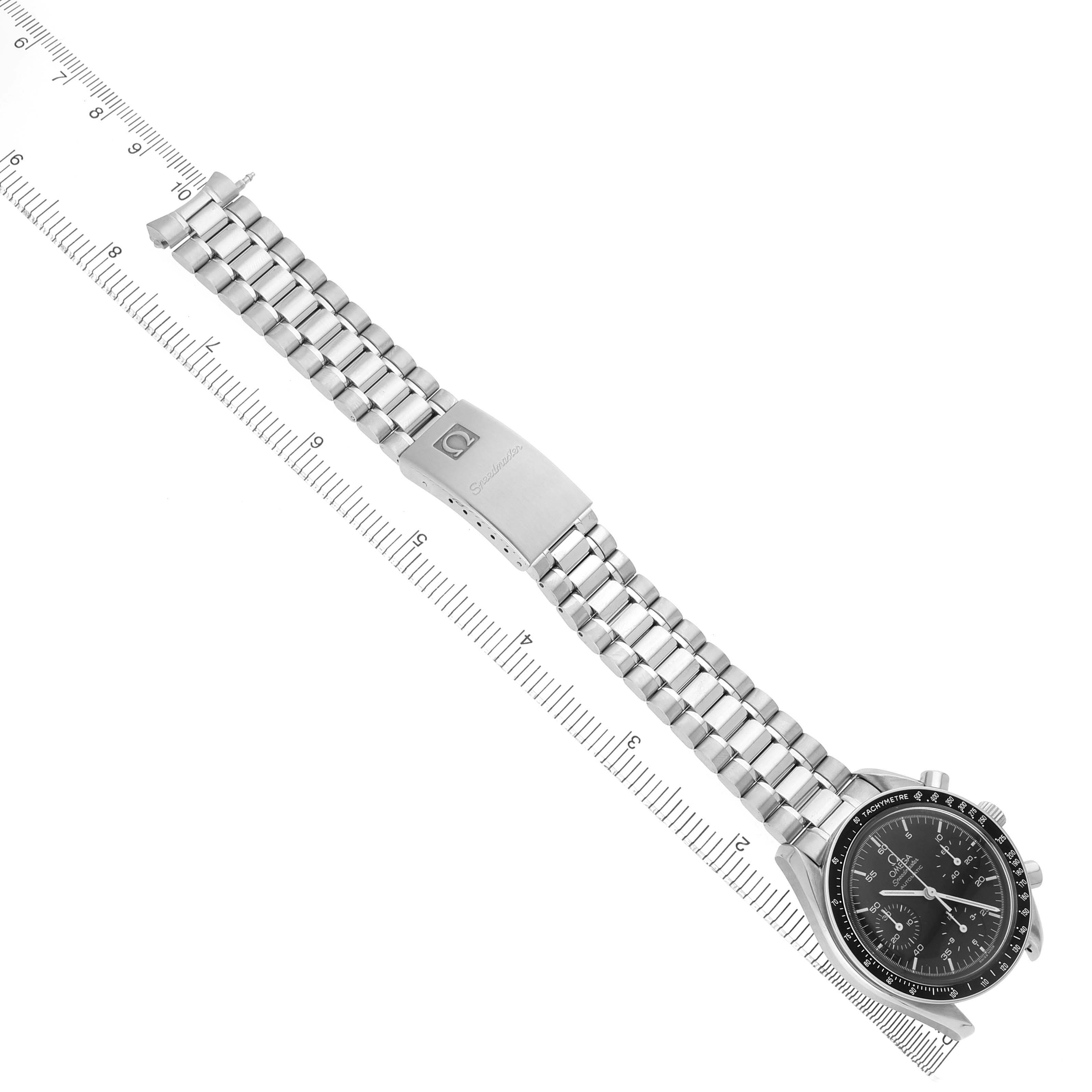 The Omega Speedmaster 3510.50.00 Men's Stainless Steel Black Dial watch is shown at a top-down angle, displaying the full bracelet, clasp, case, and dial next to a ruler.