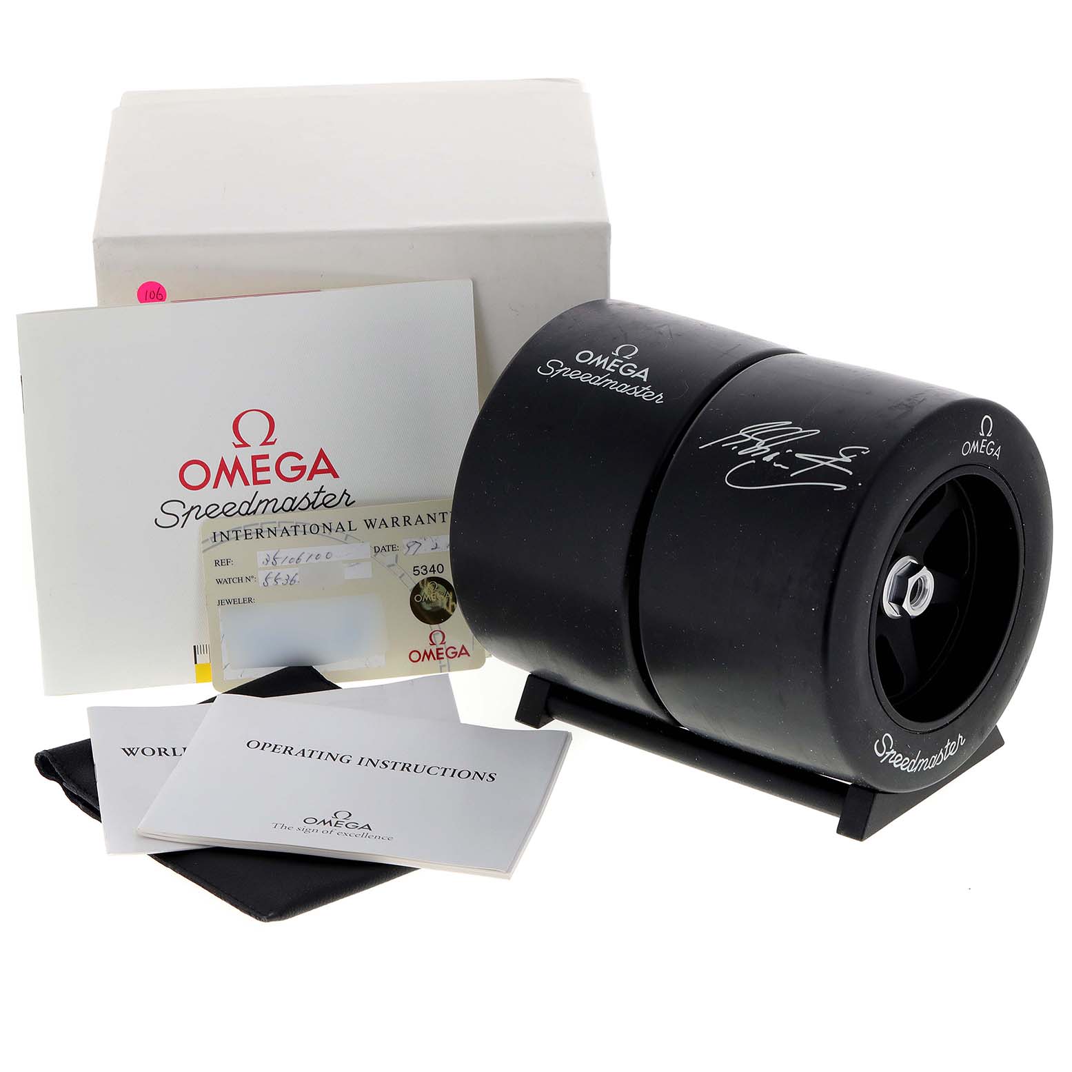 The image shows an Omega Speedmaster 3510.61.00 Men's Stainless Steel Red Dial 3510.61.00 Men's Stainless Steel Red Dial watch box, warranty card, and instruction manuals from a front angle.