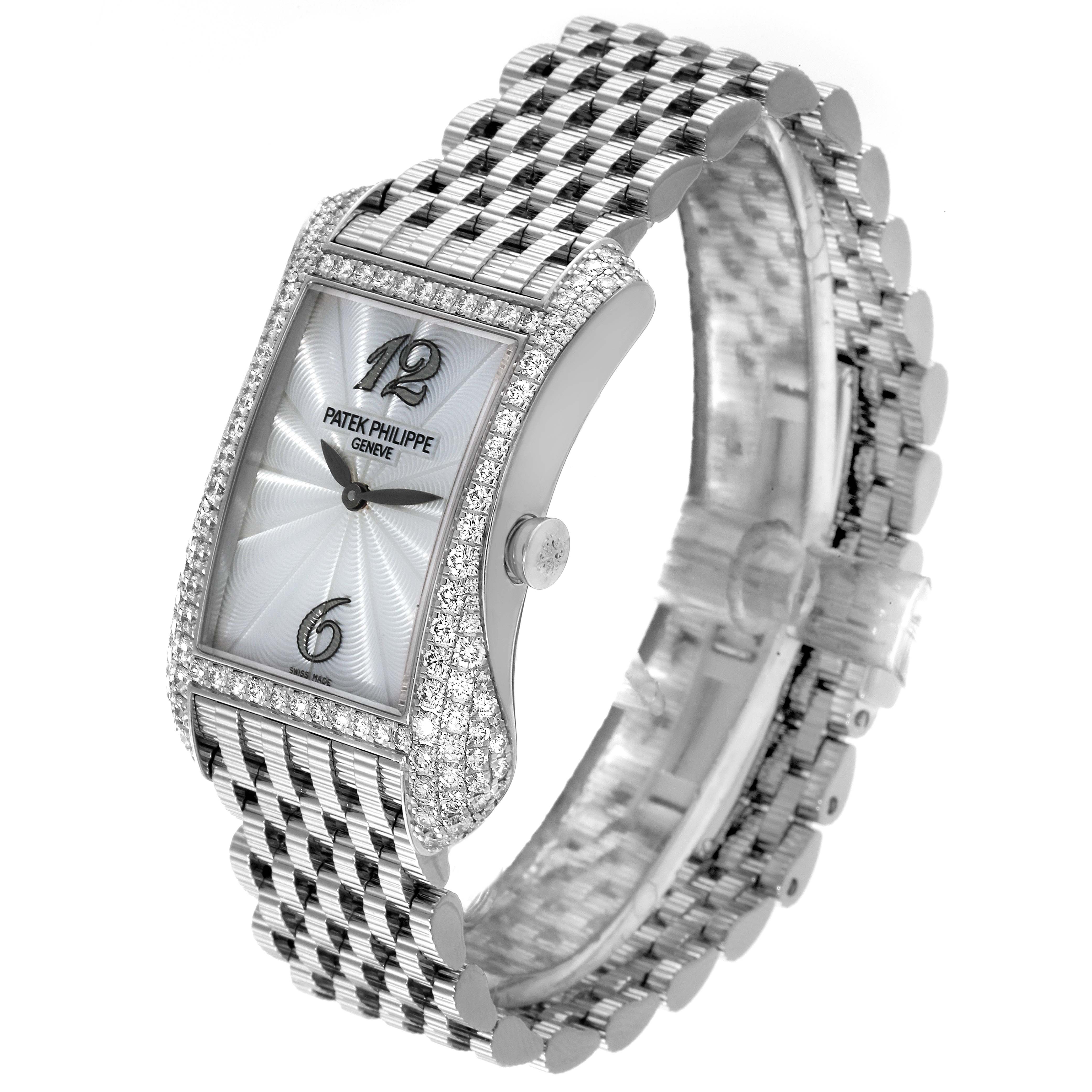 The image shows a side angle of the Patek Philippe Gondolo 4972/1G-001 Women's White Gold Mother of Pearl Dial 4972/1G-001 Women's White Gold Mother of Pearl Dial watch, highlighting its diamond-studded case, dial, and bracelet.