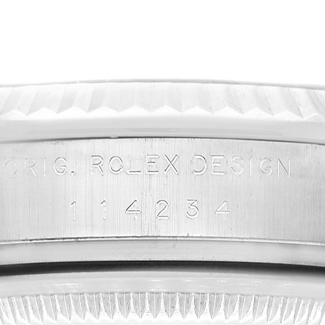 The image shows an angled close-up of the model and serial number engraving on the side of the Rolex Air-King 114234 Men's Stainless Steel Black Dial 114234 Men's Stainless Steel Black Dial watch case.