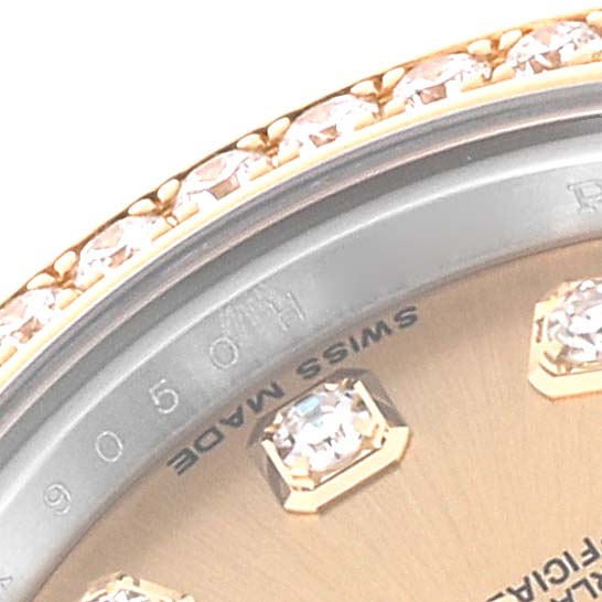 This close-up image of a Rolex Datejust 179383 Women's Steel and Gold (two tone) Champagne Dial 179383 Women's Steel and Gold (two tone) Champagne Dial watch shows its diamond-studded bezel and part of the dial with diamond hour markers.