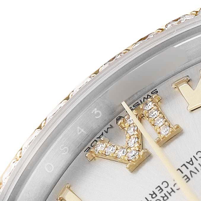 This close-up of the Rolex Mid-Size M278383RBR-0004 Women's Steel and Gold (two tone) Silver Dial model shows the bezel, diamond-set hour markers, and partial dial with hands.