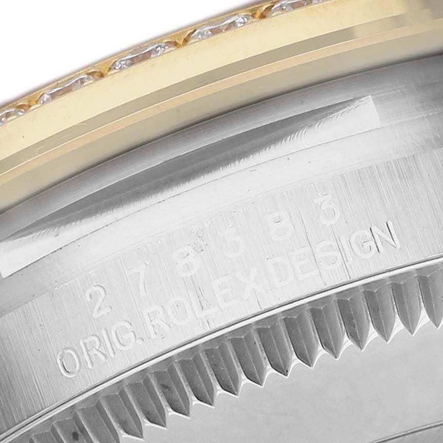 The image shows a close-up of the Rolex Mid-Size M278383RBR-0004 Women's Steel and Gold (two tone) Silver Dial watch's side, featuring the engraved model number and part of the bezel.