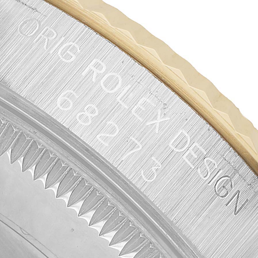 The image shows a close-up of the engraved side of a Rolex Datejust 68273 Women's Steel and Gold (two tone) Champagne Dial bezel with design details.
