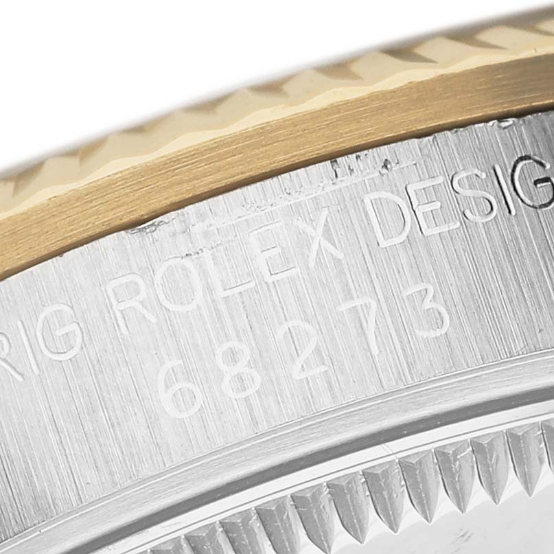The image shows a close-up of the side and bezel of a Rolex Mid-Size 68273 Women's Stainless Steel White Dial model, highlighting the engraved serial number.