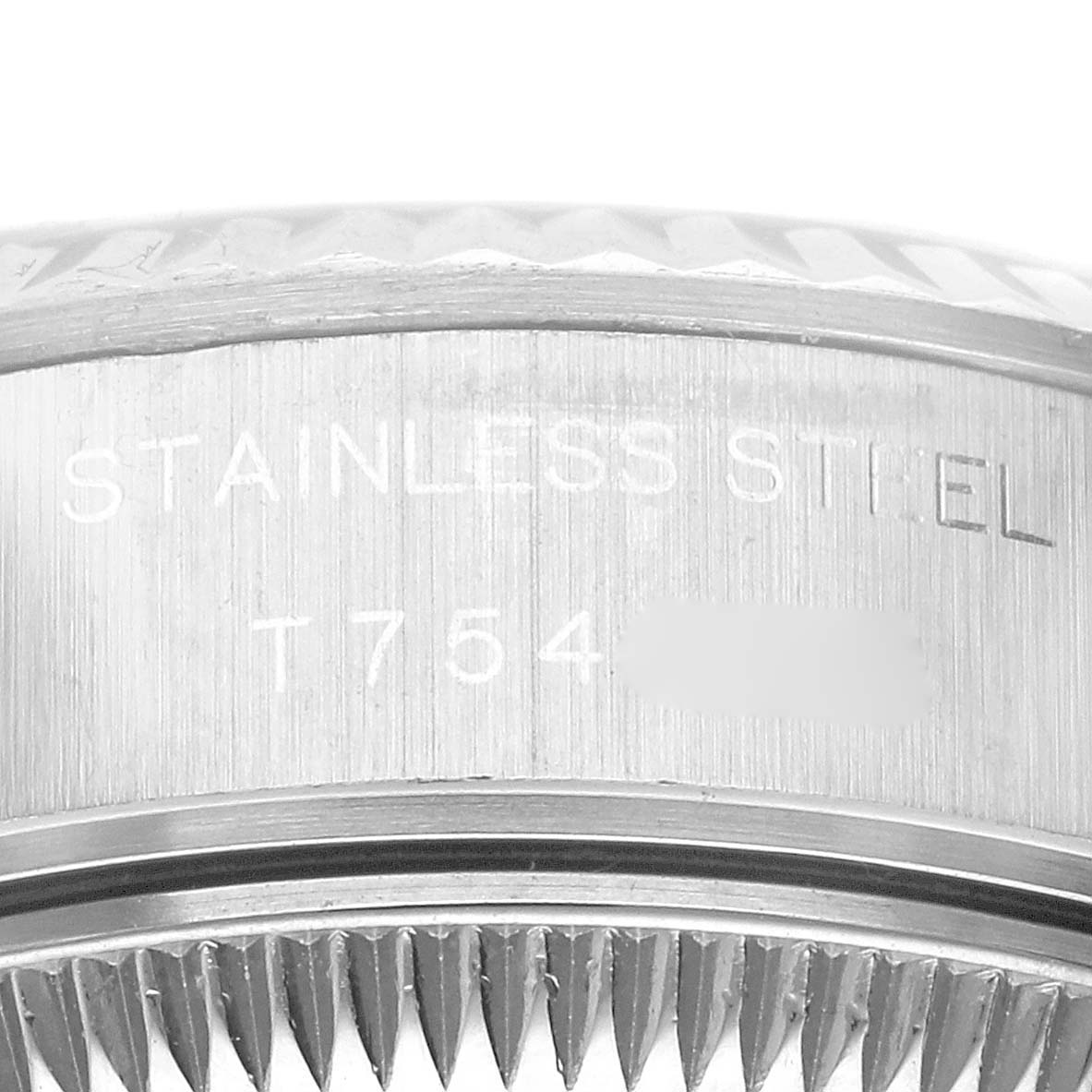 The image shows a close-up of the side of a Rolex Datejust 69174 Women's Stainless Steel Pink Dial bezel, displaying "STAINLESS STEEL" engraving.