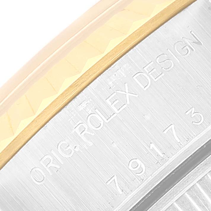 The image shows a close-up angle of the bezel with "ORIG. ROLEX DESIGN" engraving on a Rolex Datejust 79173 Women's Steel and Gold (two tone) Champagne Dial 79173 Women's Steel and Gold (two tone) Champagne Dial watch.
