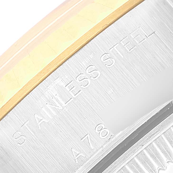 This image shows a close-up of the side of a Rolex Datejust 79173 Women's Steel and Gold (two tone) Champagne Dial 79173 Women's Steel and Gold (two tone) Champagne Dial watch, highlighting the stainless steel component and engraved text.