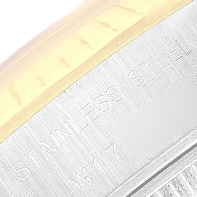 This close-up image shows the side and back of the casing of a Rolex Datejust 69173 Women's Steel and Gold (two tone) Champagne Dial 69173 Women's Steel and Gold (two tone) Champagne Dial watch with "STAINLESS STEEL" engraved.