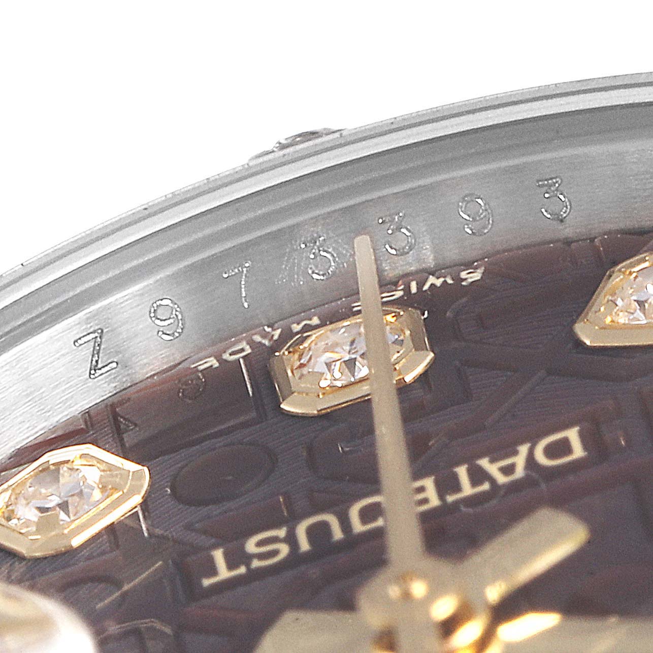 Close-up of a Rolex Datejust 179313 Women's Steel and Gold (two tone) Mother of Pearl Dial 179313 Women's Steel and Gold (two tone) Mother of Pearl Dial watch showing the serial number, part of the dial with diamonds, and the hands.