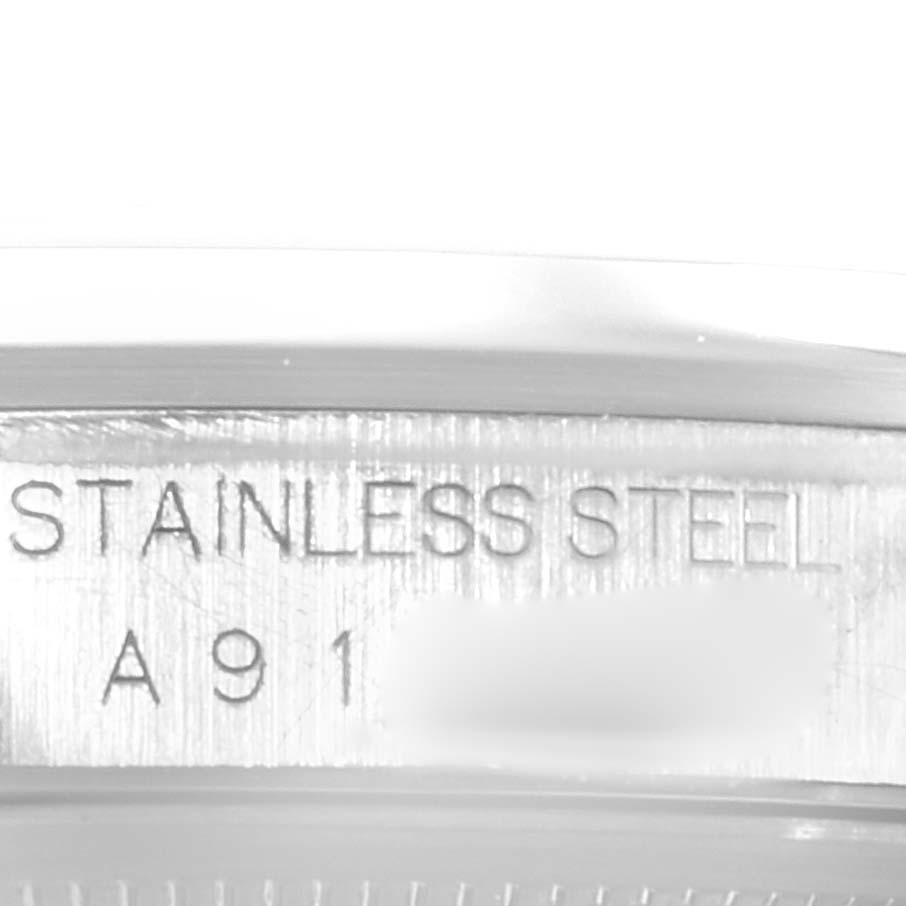 This image shows a close-up view of the stainless steel casing and partial serial number of a Rolex Datejust 16200 Men's Stainless Steel White Dial 16200 Men's Stainless Steel White Dial watch.