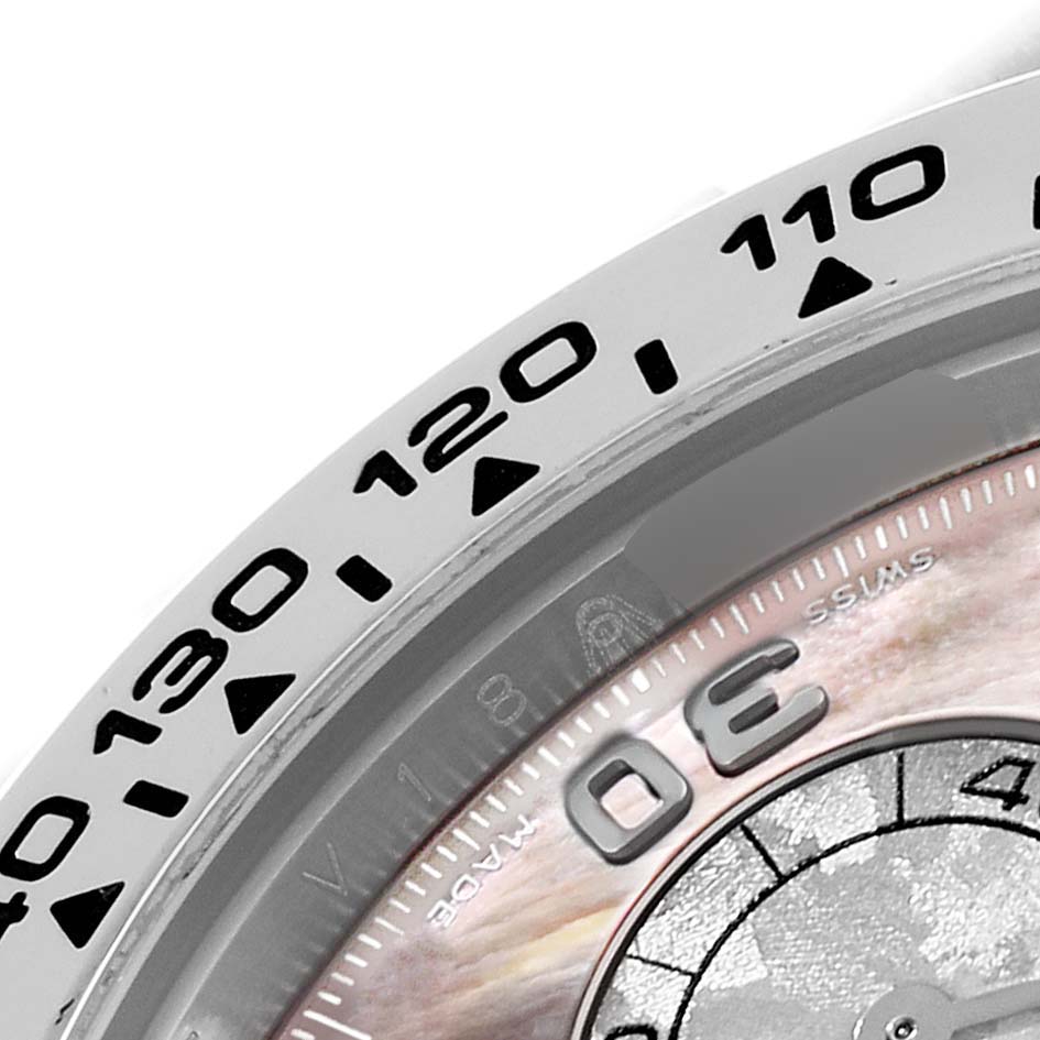 This close-up image of a Rolex Daytona 116519LN Men's White Gold Mother of Pearl Dial 116519LN Men's White Gold Mother of Pearl Dial watch shows part of the bezel with numerals and a portion of the dial.