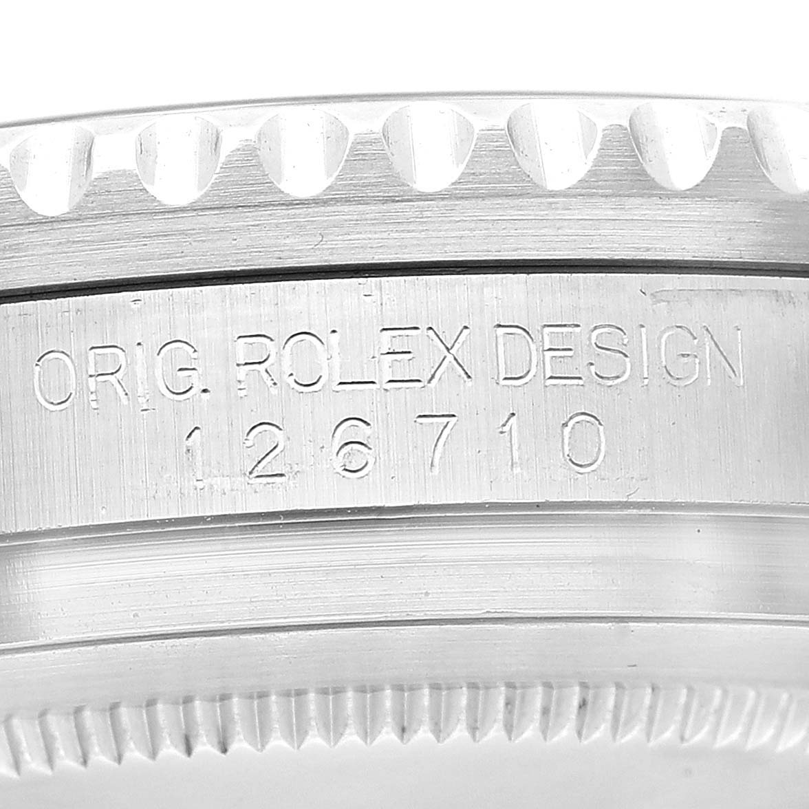 This close-up image shows the engraved side profile of a Rolex GMT-Master 126710 Men's Stainless Steel Black Dial 126710 Men's Stainless Steel Black Dial model 126710, highlighting the original design and model number.