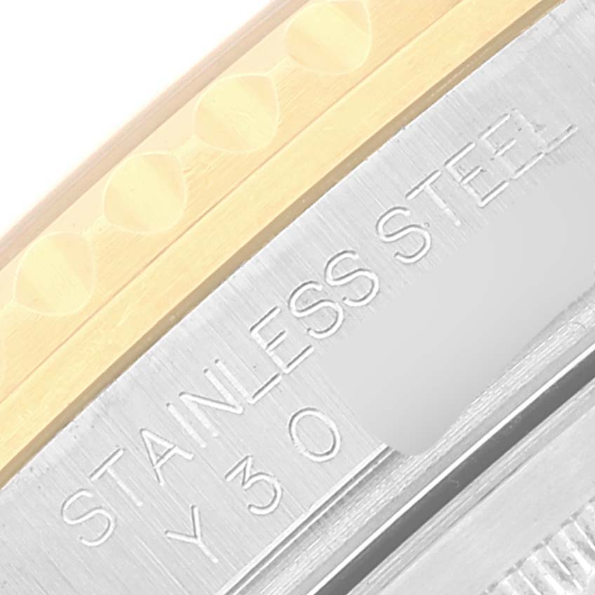 The image shows a close-up of the side of a Rolex GMT-Master 16713 Men's Steel and Gold (two tone) Brown Dial 16713 Men's Steel and Gold (two tone) Brown Dial watch case, highlighting the stainless steel marking and part of the bezel.