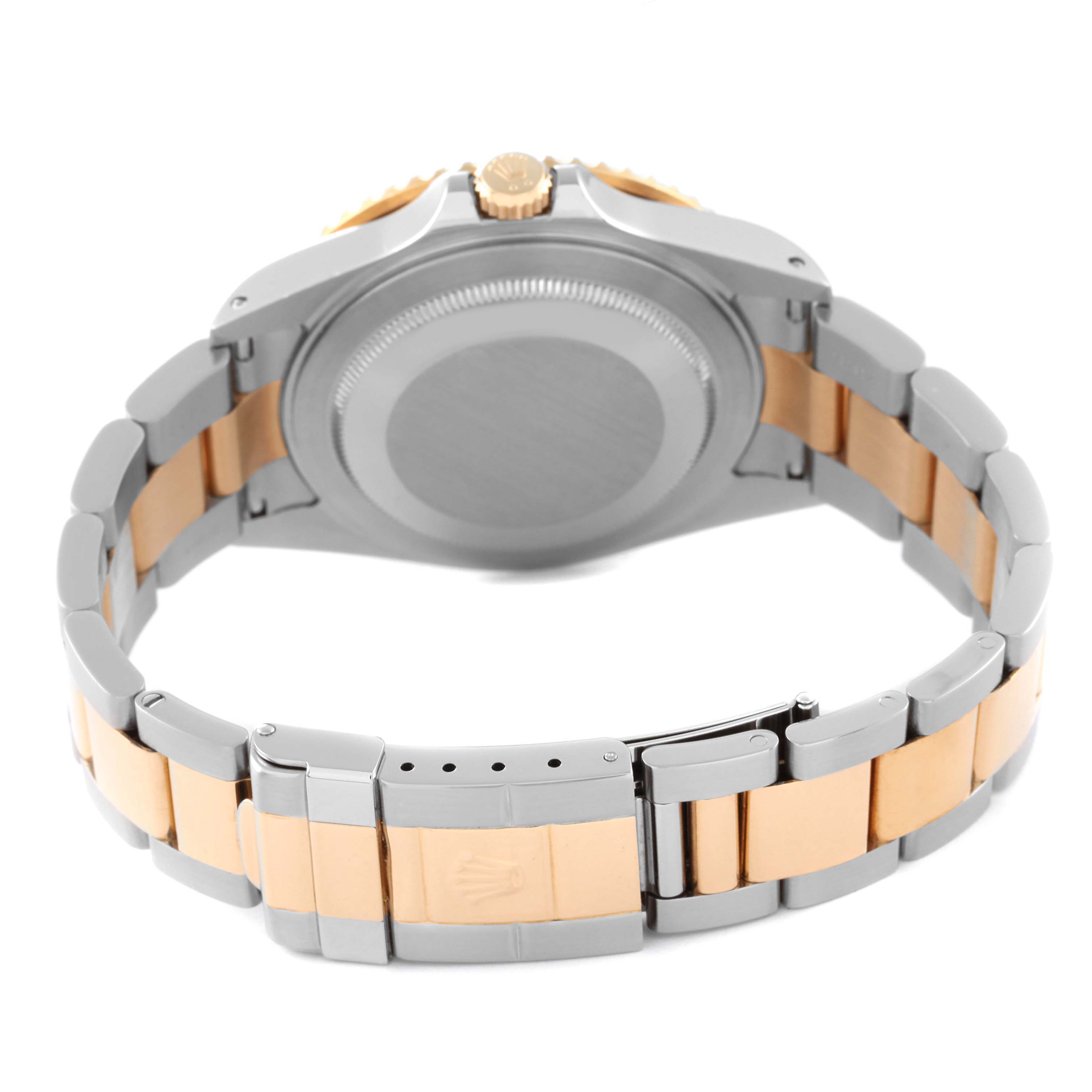 This image shows the back of a Rolex GMT-Master 16713 Men's Steel and Gold (two tone) Brown Dial 16713 Men's Steel and Gold (two tone) Brown Dial watch with a partially extended two-tone metal bracelet.