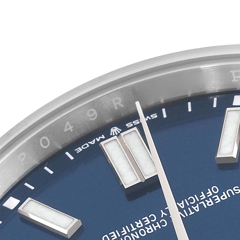 This image shows a close-up of the dial and bezel of a Rolex Oyster Perpetual 124300 Men
s Stainless Steel Blue Dial 124300 Men
s Stainless Steel Blue Dial watch, highlighting the "Swiss Made" marking.