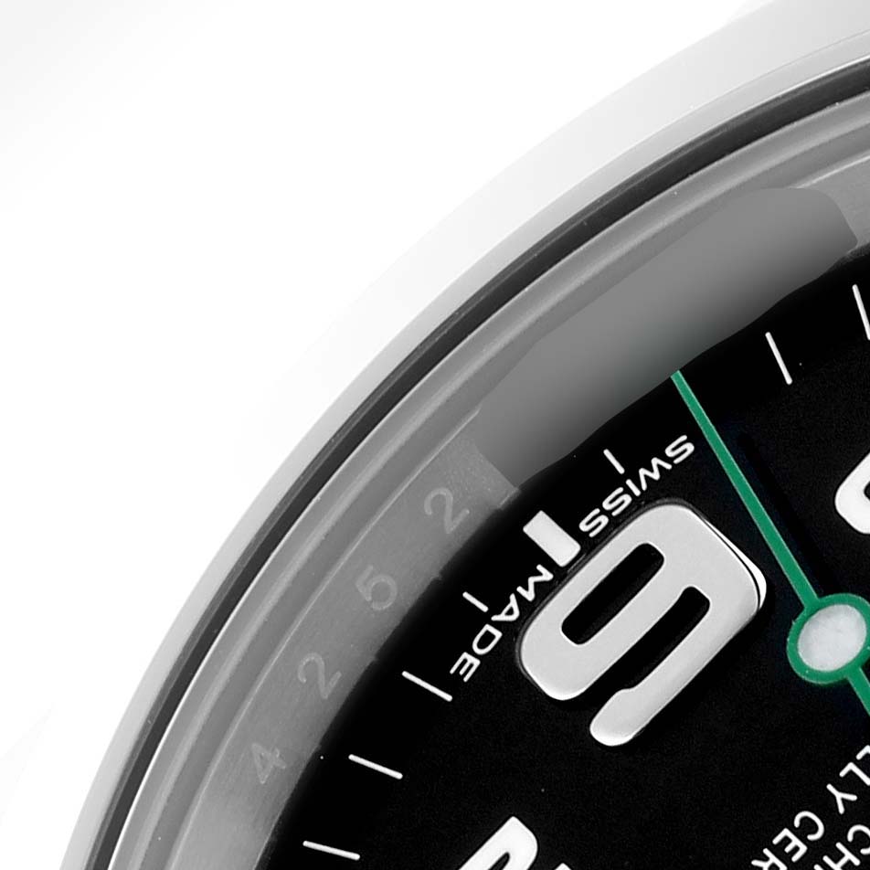 This image shows a close-up of the Rolex Air-King 116900 Men's Stainless Steel Black Dial 116900 Men's Stainless Steel Black Dial watch's dial, featuring the number "9" and part of the minute scale.