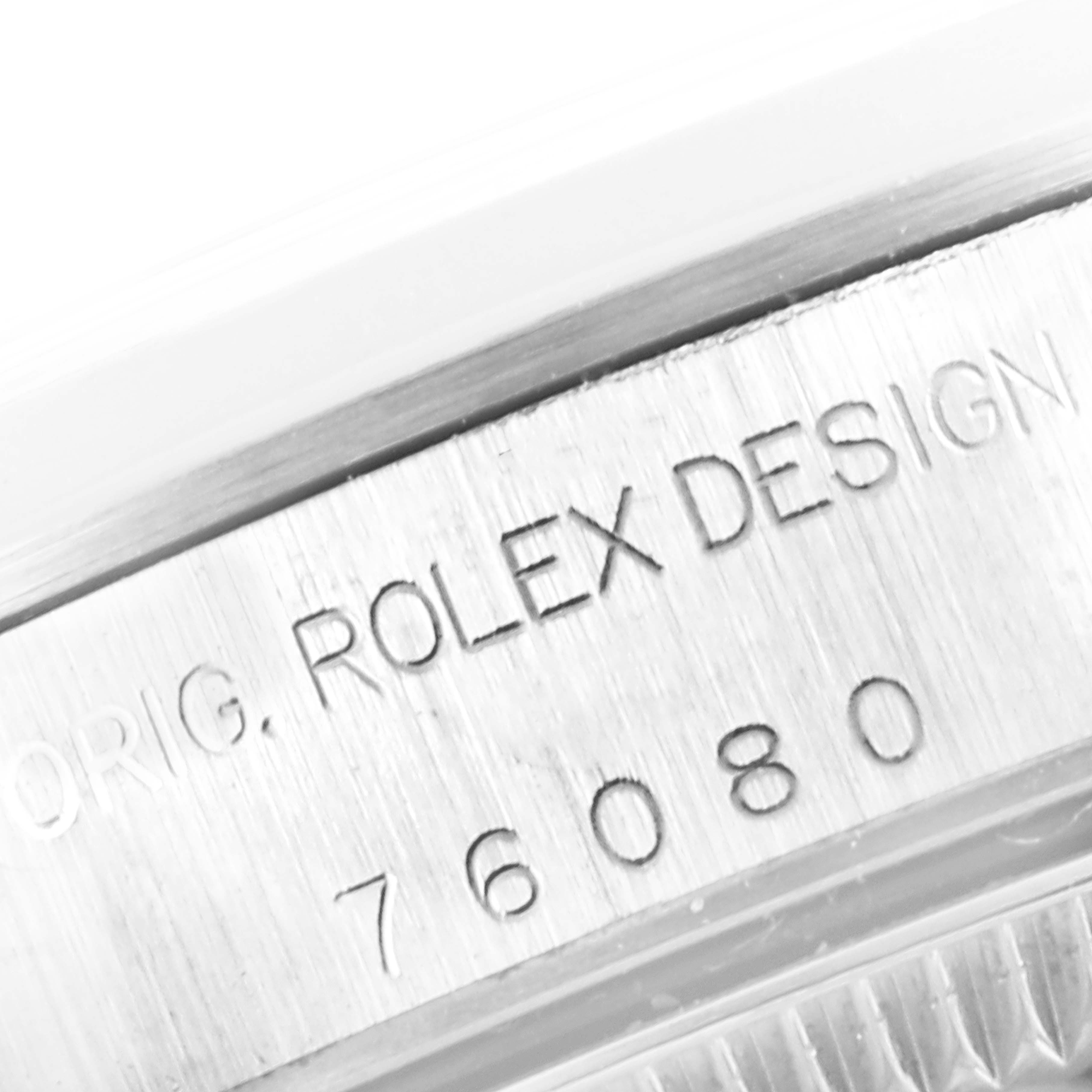 The image shows a close-up of the case back of a Rolex Oyster Perpetual 76080 Women's Stainless Steel Black Dial 76080 Women's Stainless Steel Black Dial watch, revealing the engravings.