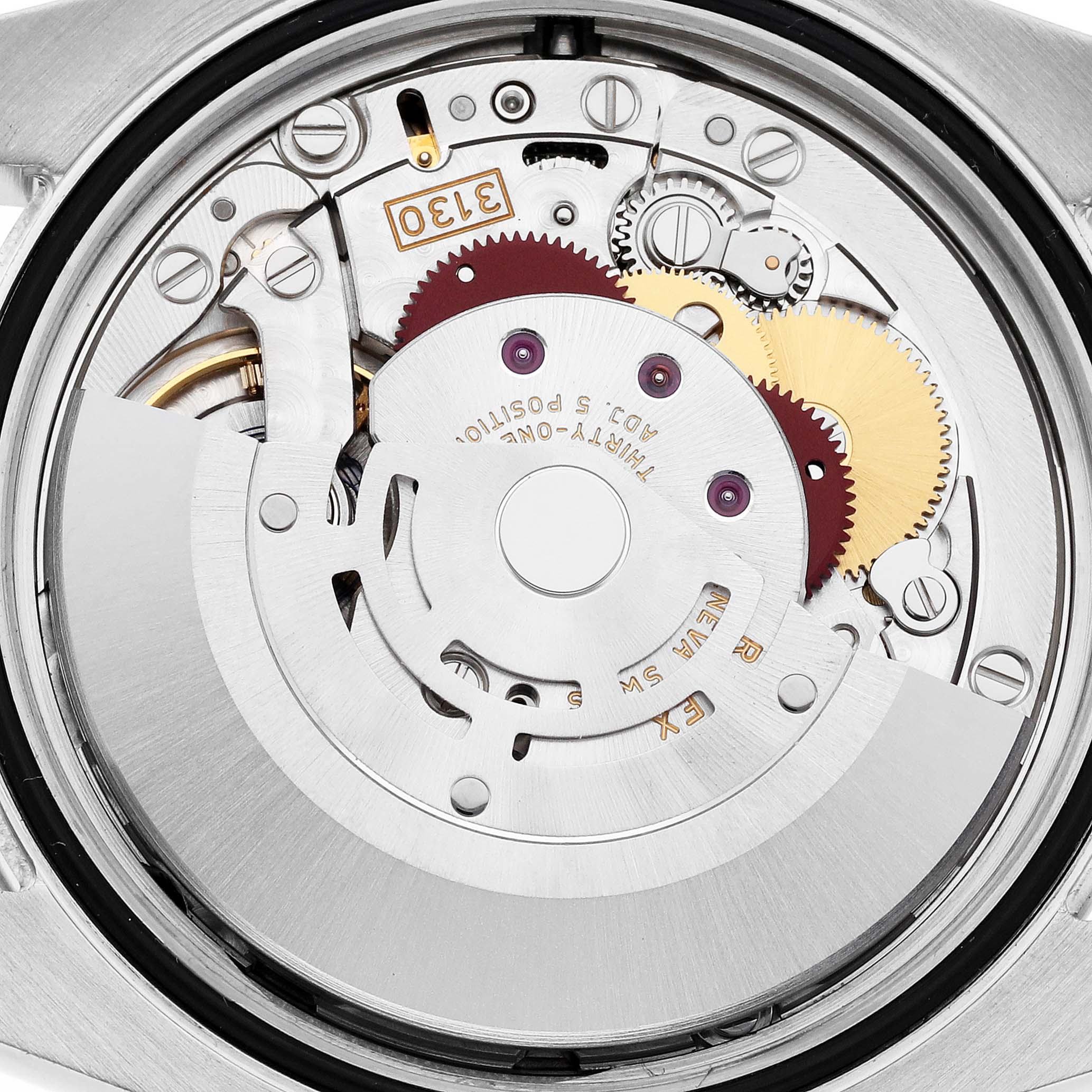 This image shows a close-up of the movement mechanism inside a Rolex Oyster Perpetual 116000 Men's Stainless Steel Purple Dial 116000 Men's Stainless Steel Purple Dial watch, highlighting the gears and components.