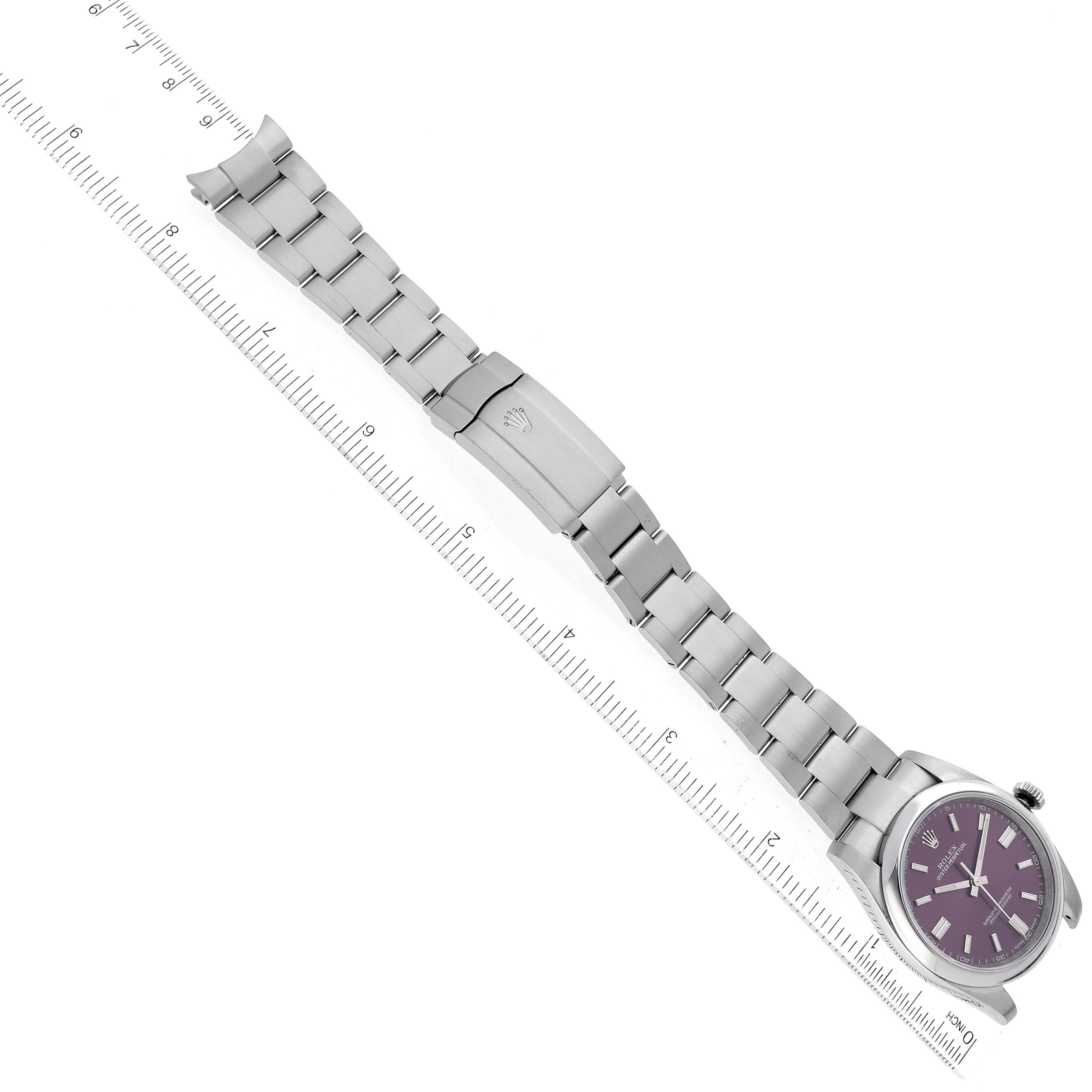 This image shows a stainless steel Rolex Oyster Perpetual 116000 Men's Stainless Steel Purple Dial 116000 Men's Stainless Steel Purple Dial watch and bracelet, displayed diagonally with a measuring ruler.