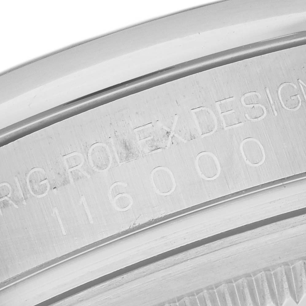 The image shows the serial number and "ROLEX DESIGN" engraving on the case back rim of a Rolex Oyster Perpetual 116000 Men's Stainless Steel Purple Dial 116000 Men's Stainless Steel Purple Dial watch.