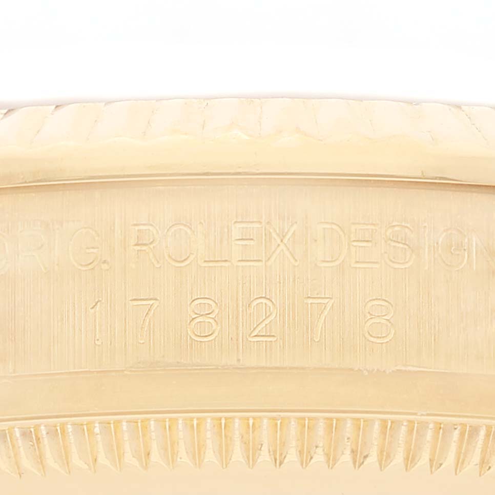 This image shows a close-up of the side of a Rolex President 178278 Women
s Yellow Gold Champagne Dial 178278 Women
s Yellow Gold Champagne Dial model, focusing on the serial number engraved on the case.