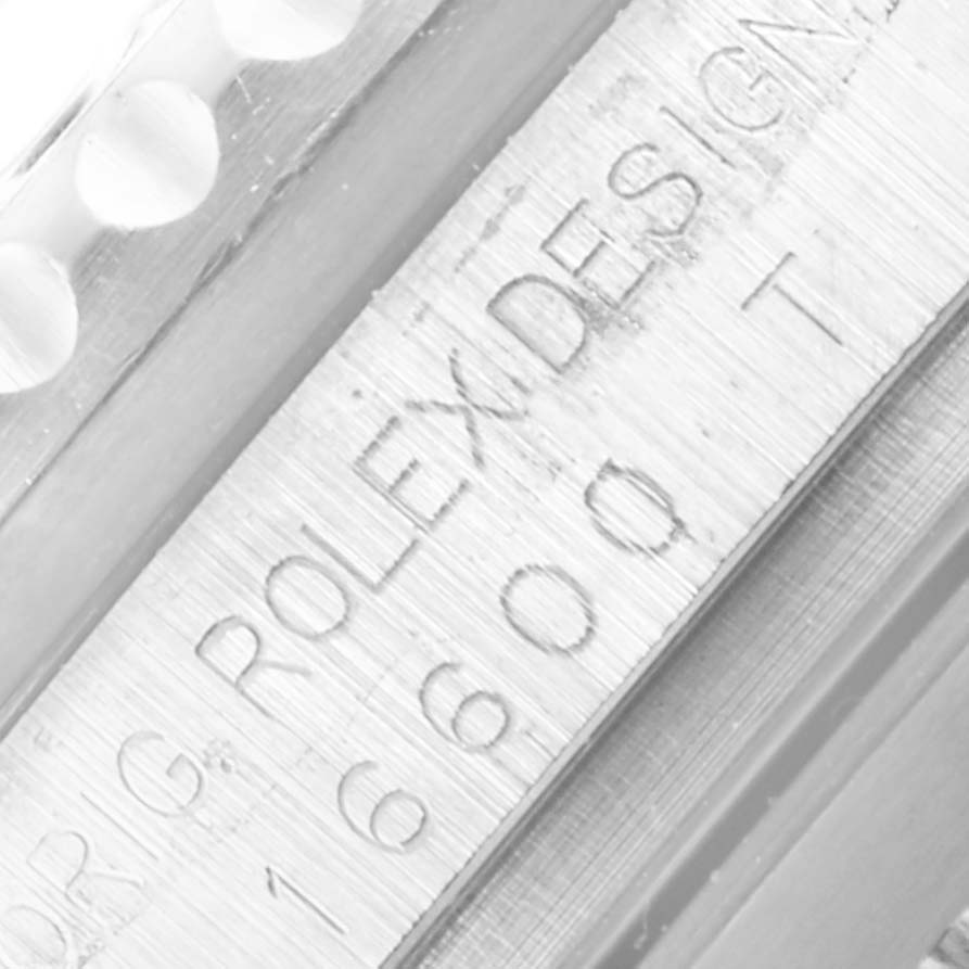 Close-up of the bezel and casing with engraved text on a Rolex Sea-Dweller 16600 Men
s Stainless Steel Black Dial 16600 Men
s Stainless Steel Black Dial watch.