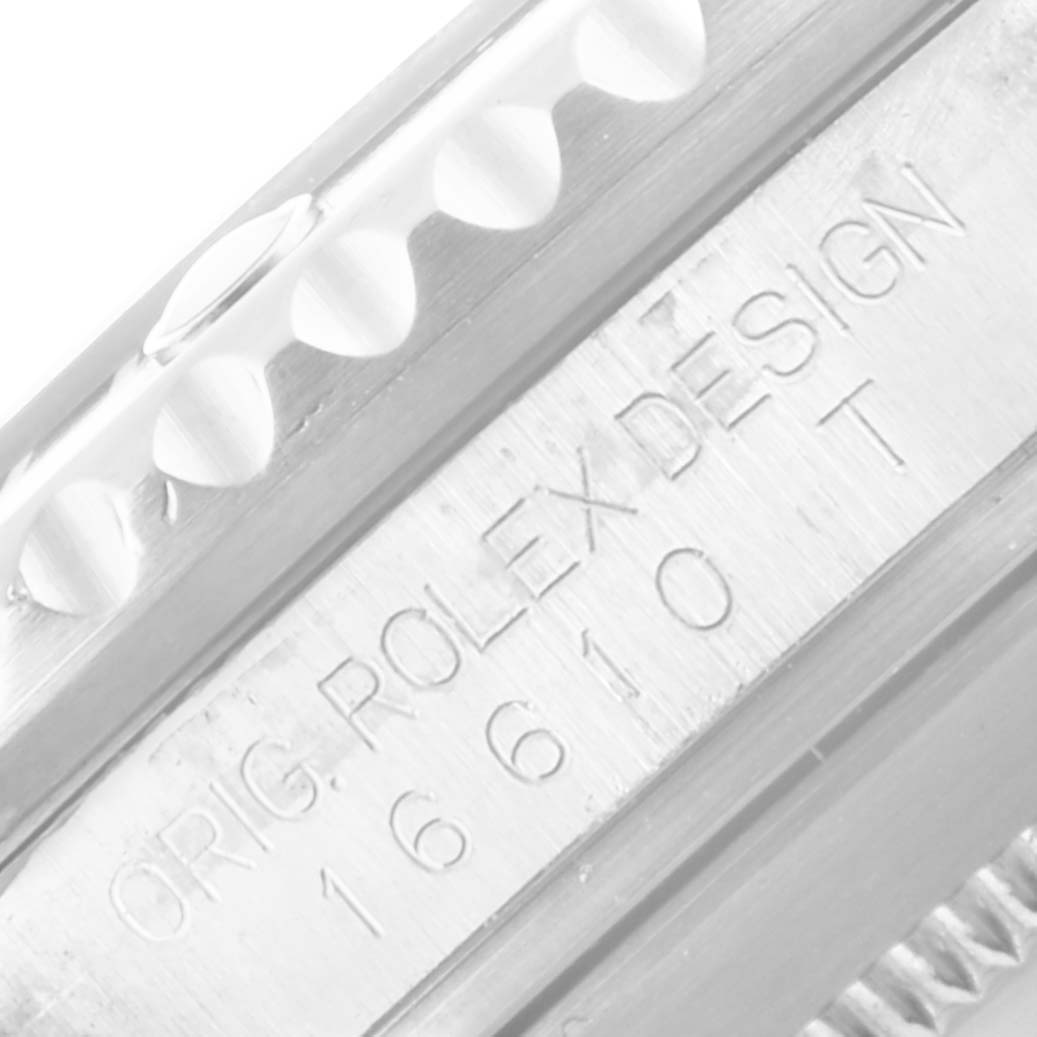 This image shows a close-up of the model number and design engraving on a Rolex Submariner 16610 Men
s Stainless Steel Black Dial 16610 Men
s Stainless Steel Black Dial watch case.