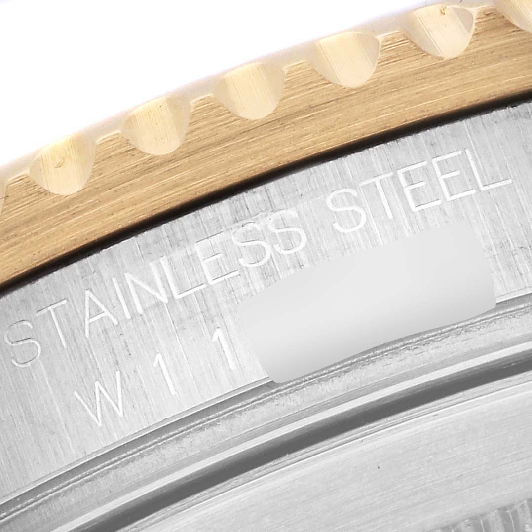 This image shows a close-up of the bezel and case of a Rolex Submariner 16613 Men's Steel and Gold (two tone) Blue Dial 16613 Men's Steel and Gold (two tone) Blue Dial watch.