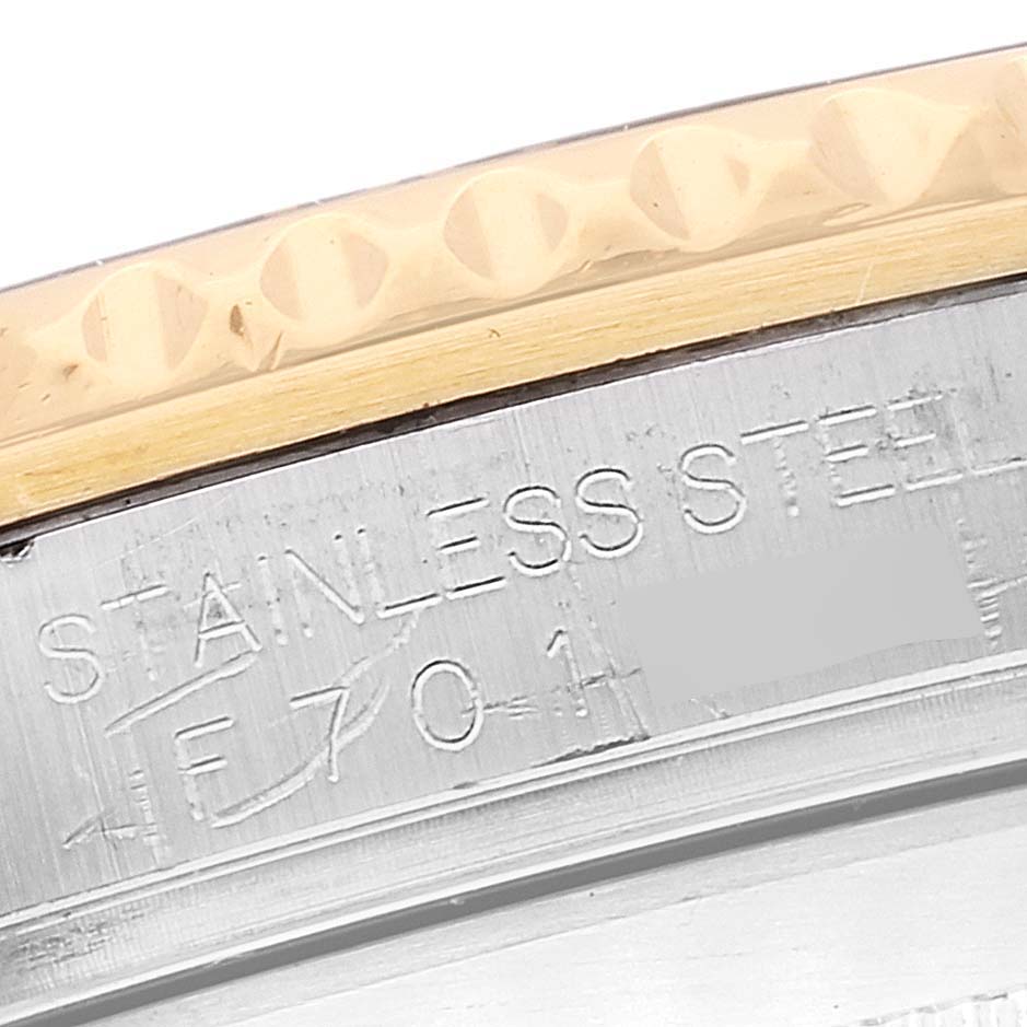 The image shows a close-up of the engraved stainless steel case back of the Rolex Submariner 16613 Men's Steel and Gold (two tone) Champagne Dial 16613 Men's Steel and Gold (two tone) Champagne Dial watch.