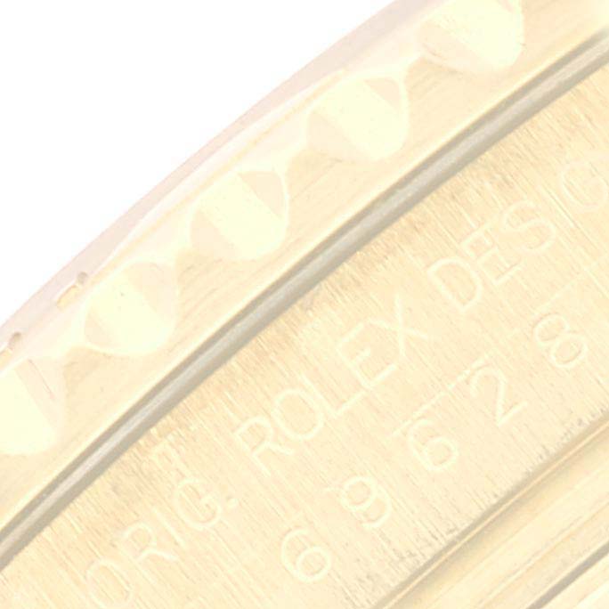 This close-up image of the Rolex Yacht-Master 69628 Women's Yellow Gold White Dial 69628 Women's Yellow Gold White Dial model shows the edge of the bezel and part of the engraved case.