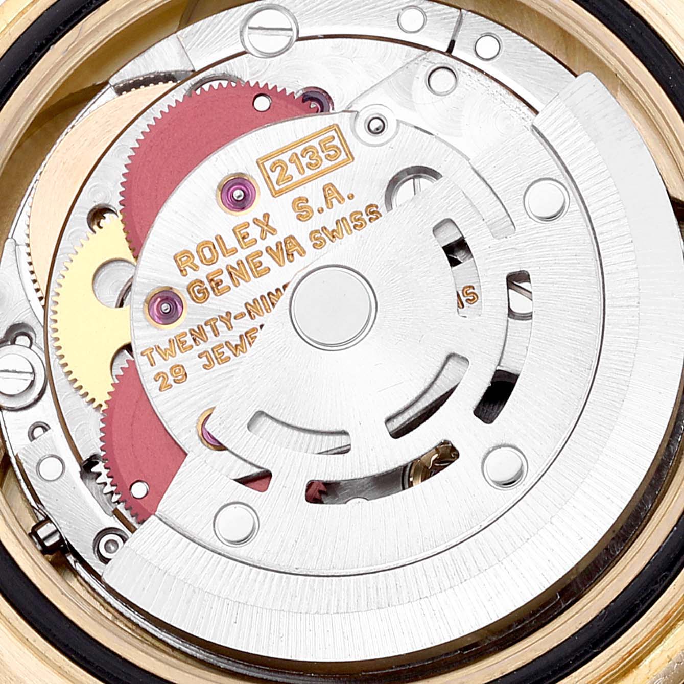 The image shows the internal mechanism of a Rolex Yacht-Master 69628 Women's Yellow Gold White Dial 69628 Women's Yellow Gold White Dial, highlighting the movement components like gears and the rotor.