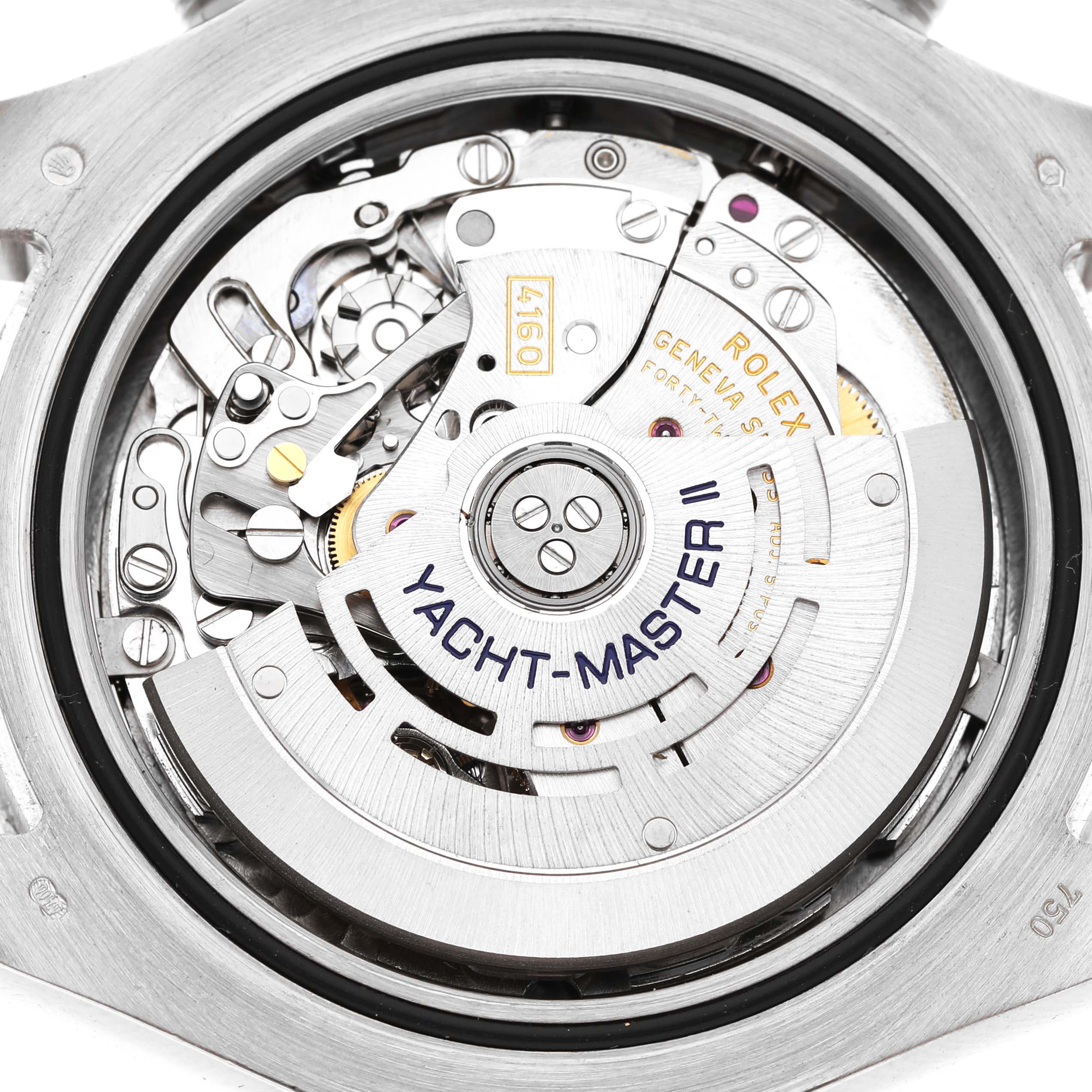The image shows the movement of a Rolex Yacht-Master 116689 Men's White Gold White Dial watch from the back, highlighting the rotor and intricate mechanical parts.