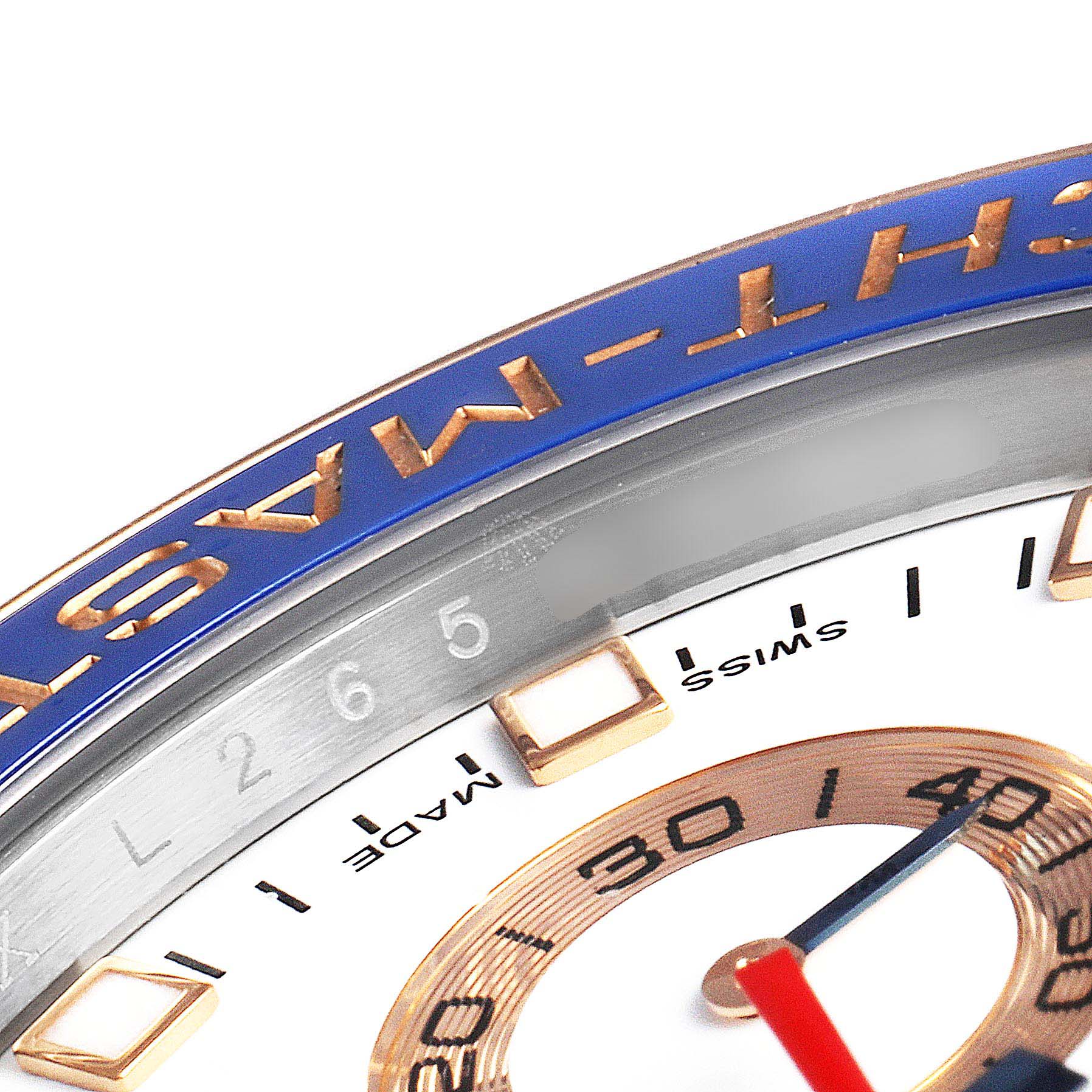 The image shows a close-up angled view of the bezel and part of the dial of a Rolex Yacht-Master 116681 Men's Steel and Gold (two tone) White Dial 116681 Men's Steel and Gold (two tone) White Dial watch.